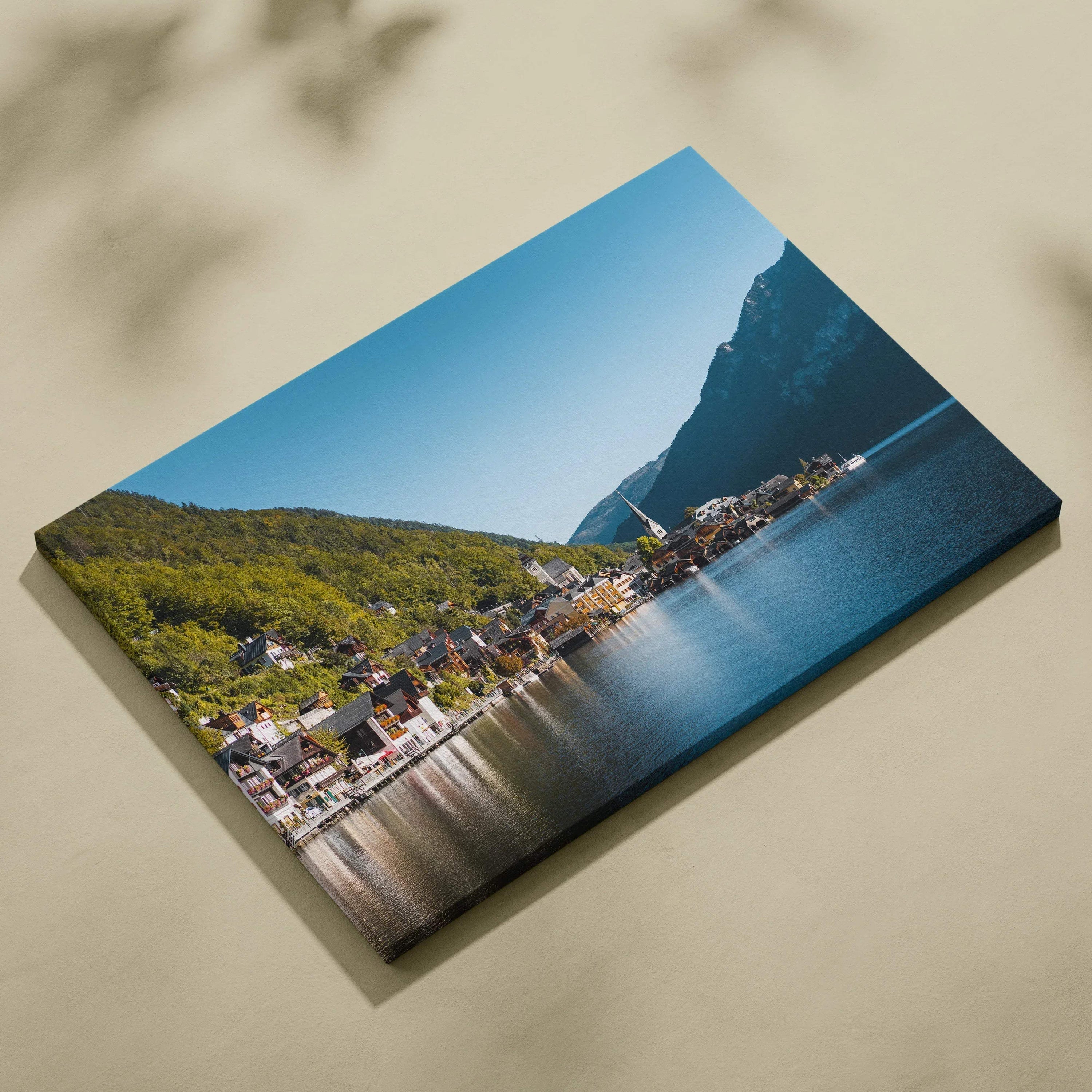 Canvas wall art print featuring digital architecture of lakeside buildings with mountain backdrop and clear blue sky.