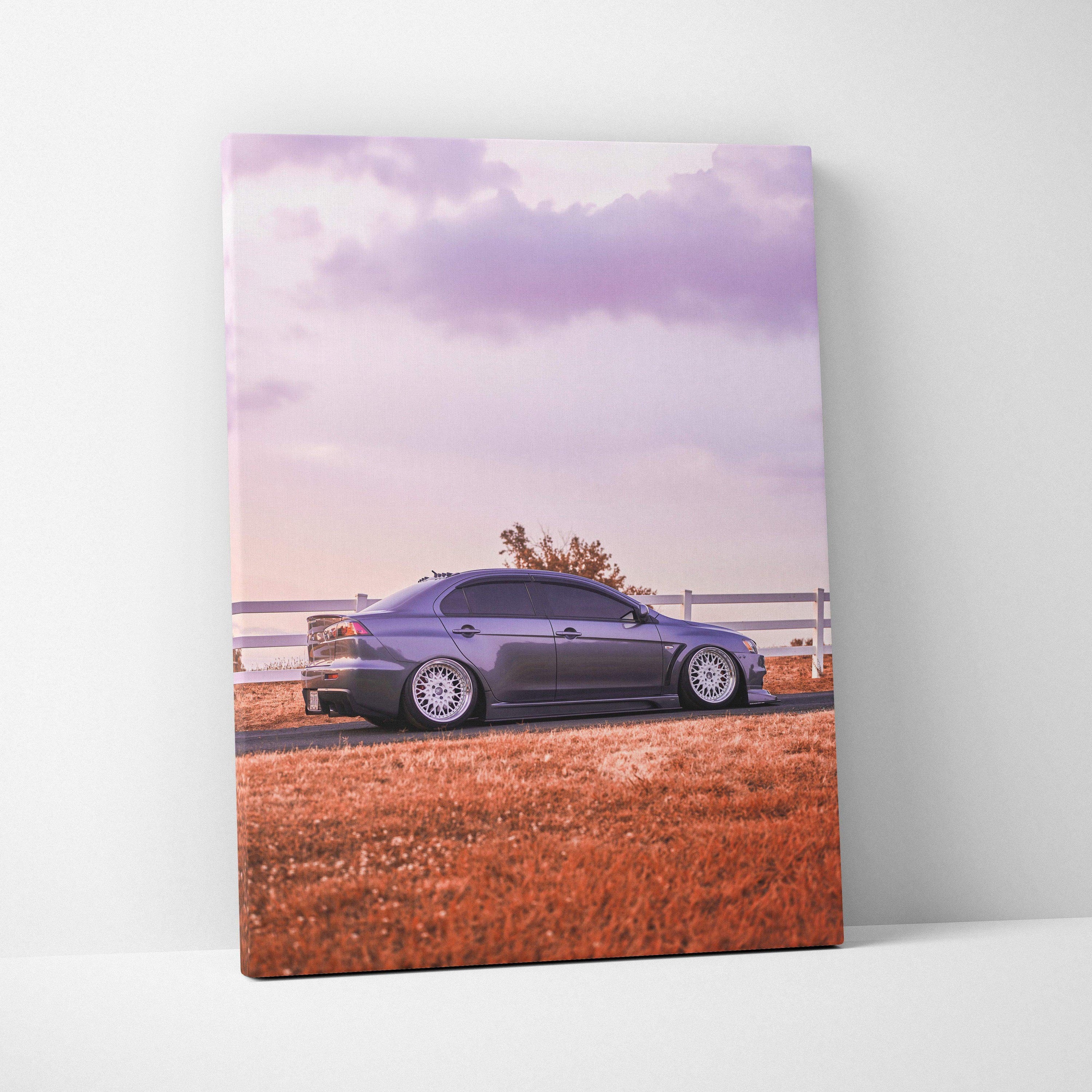 Mitsubishi Evo 10 parked by white fence with orange grass and purple sky canvas wall art.