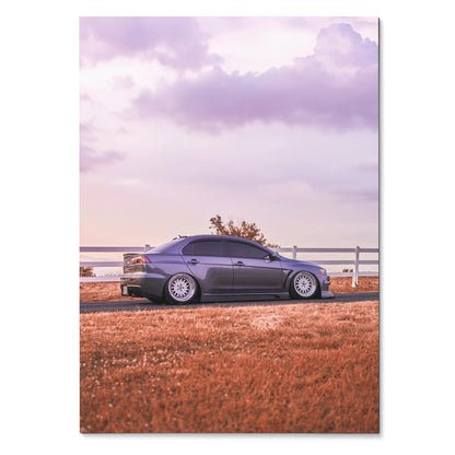Mitsubishi Evo 10 in gray parked near fence with vibrant orange grass under a purple sky poster wall art.