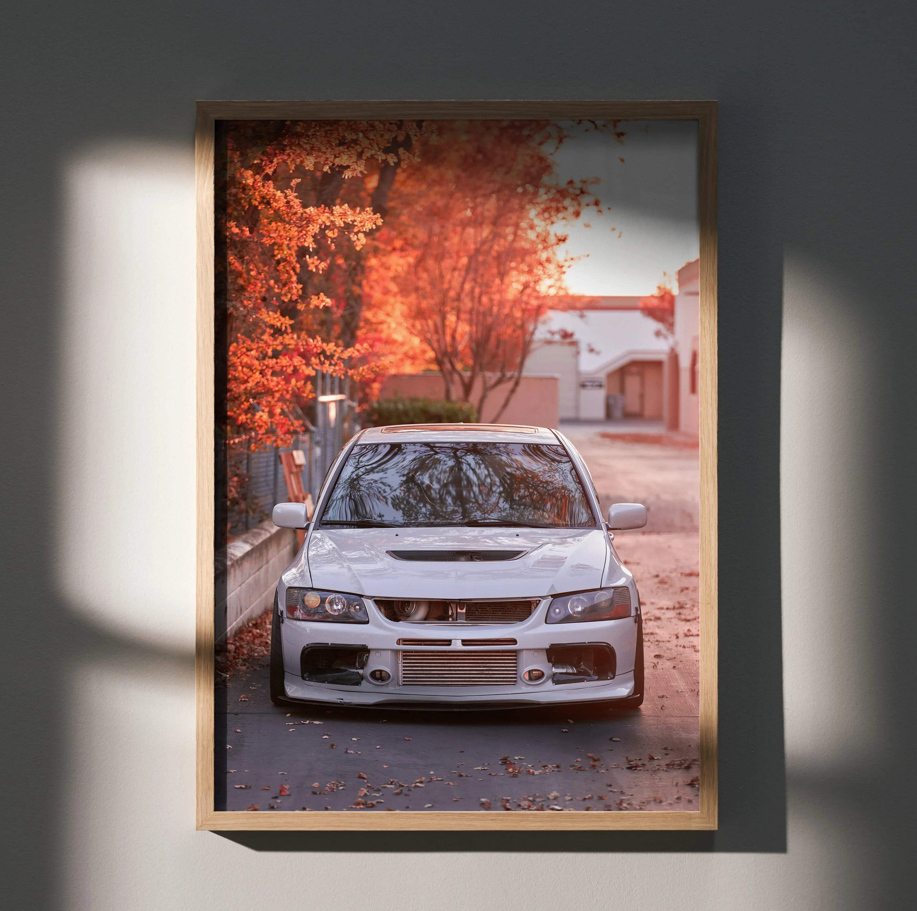 Mitsubishi Evo 8 front view poster with autumn leaves background wall art in wooden frame.