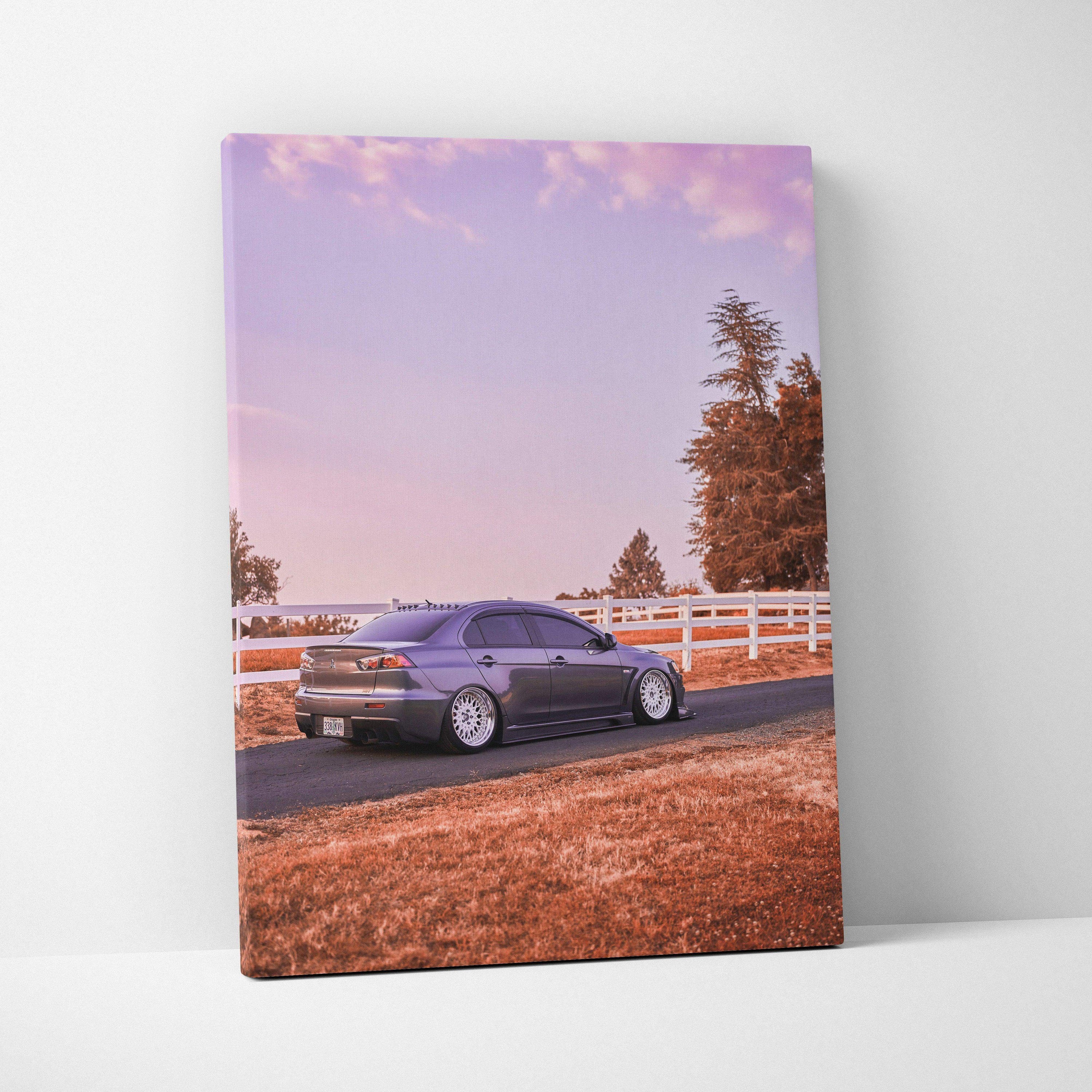 Vertical canvas art of a Mitsubishi Evo 10 parked on a rural road with pink sky backdrop wall art.