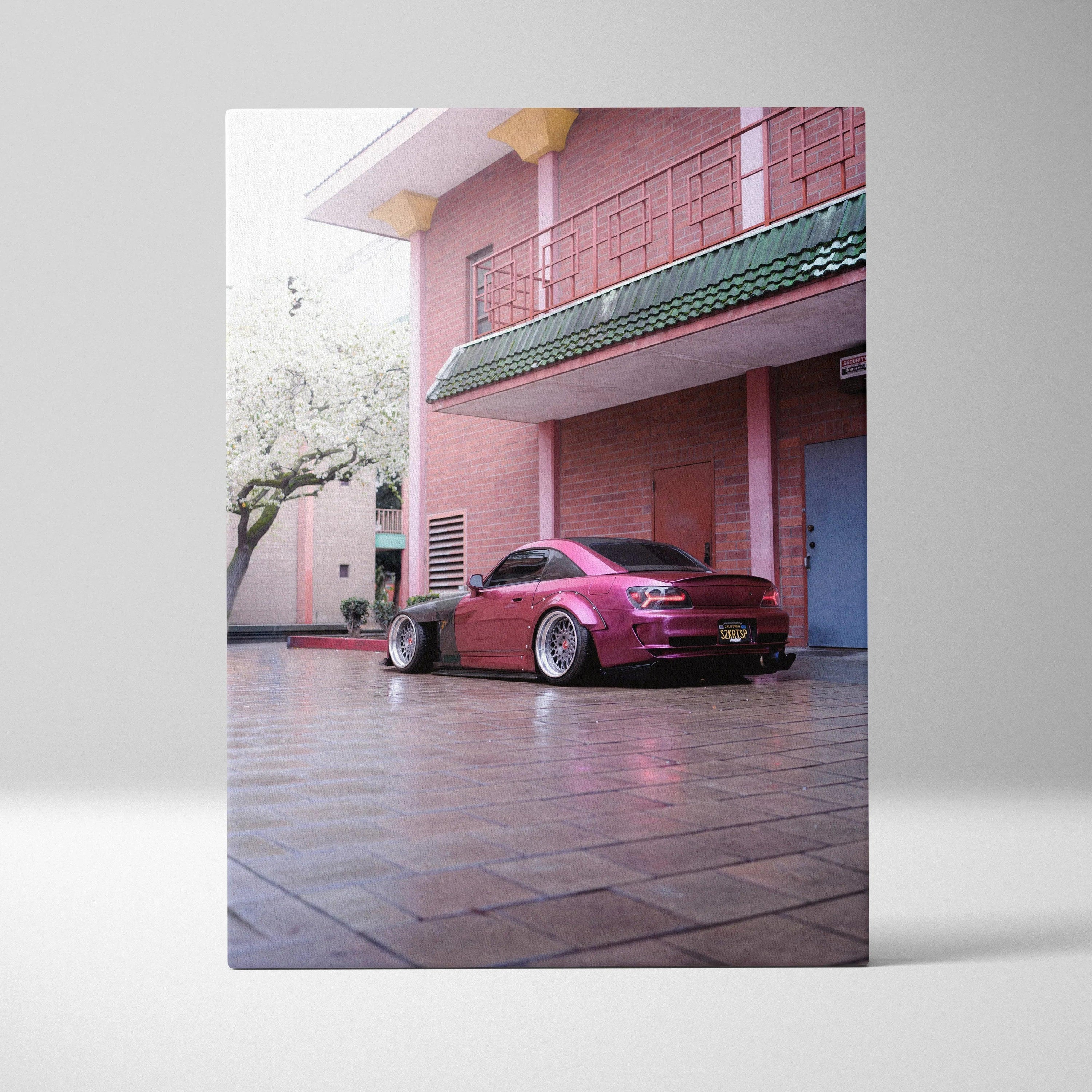 Honda S2000 sports car parked under balcony in pink building canvas wall art.