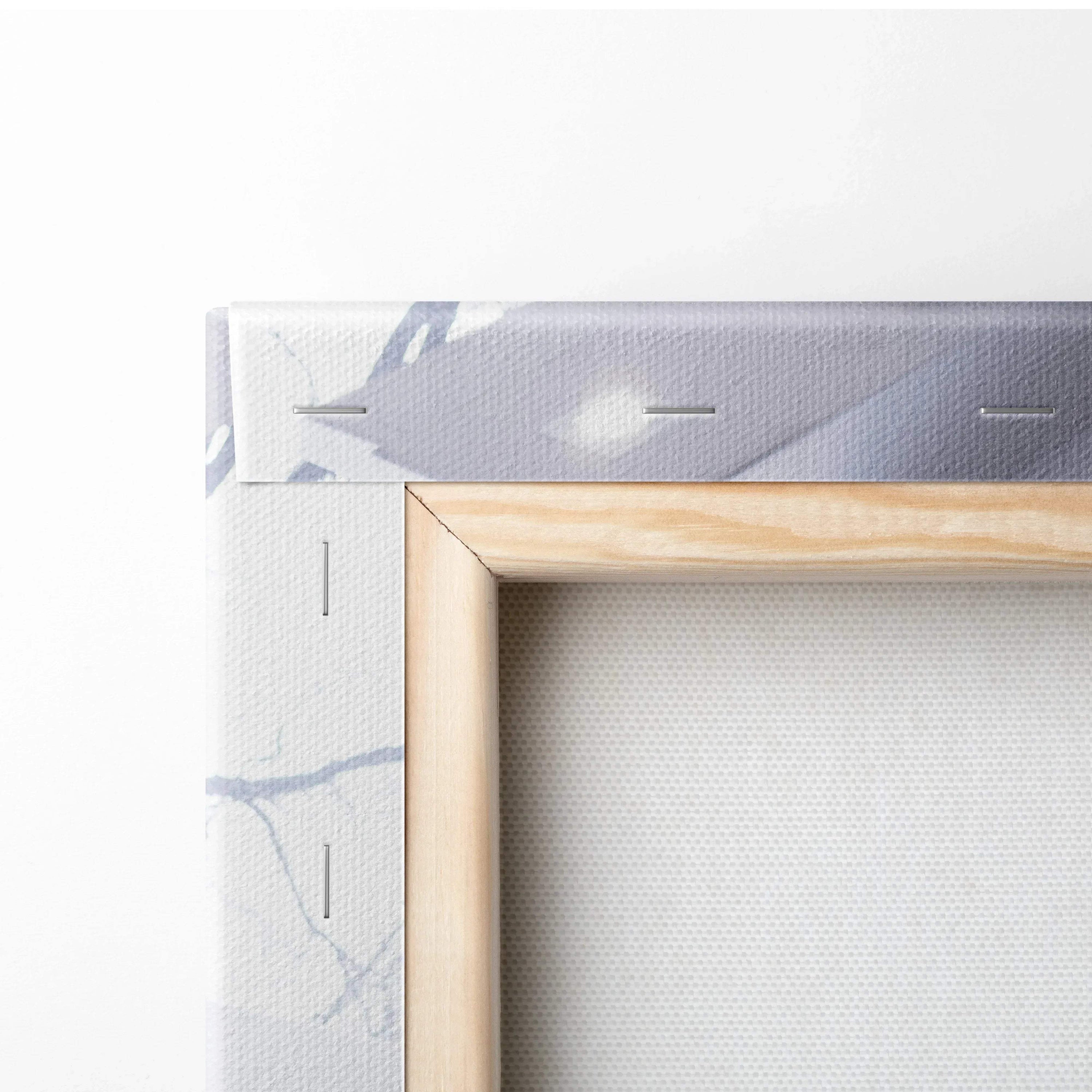 Close-up of wooden stretcher bar and white canvas with light gray patterns, showcasing wall art canvas texture.