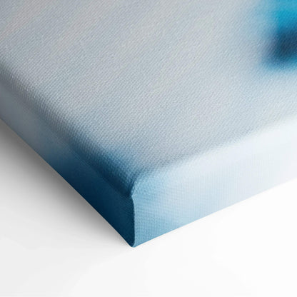 Close-up of canvas wall art corner with soft blue and white gradient colors and subtle textured surface.