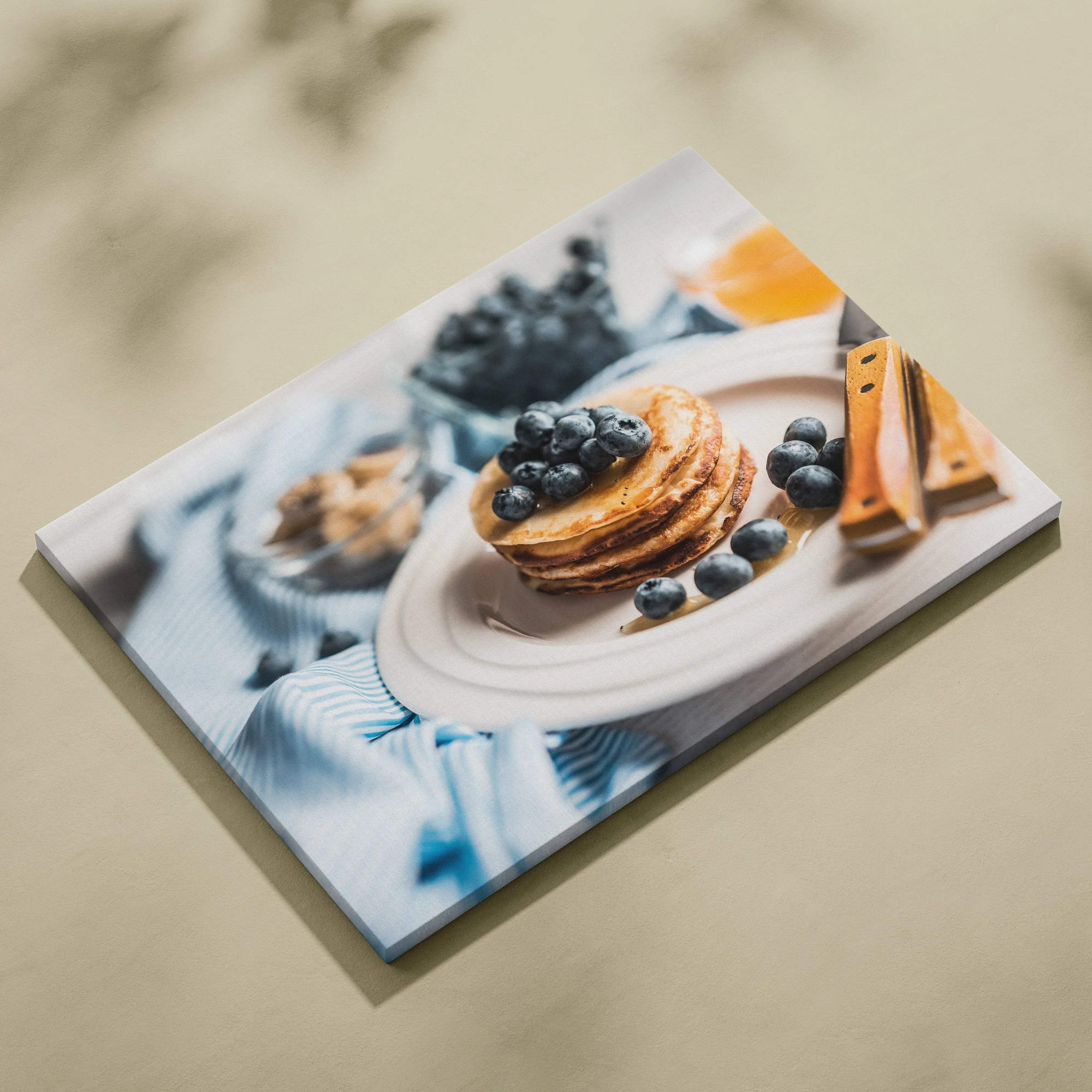 Canvas wall art featuring vibrant blueberry pancakes on a white plate with cinnamon sticks and blueberries, bright and.