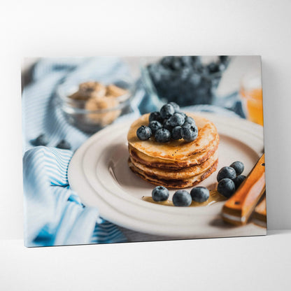 Canvas wall art of vibrant blueberry pancakes breakfast scene with fresh blueberries and utensils.