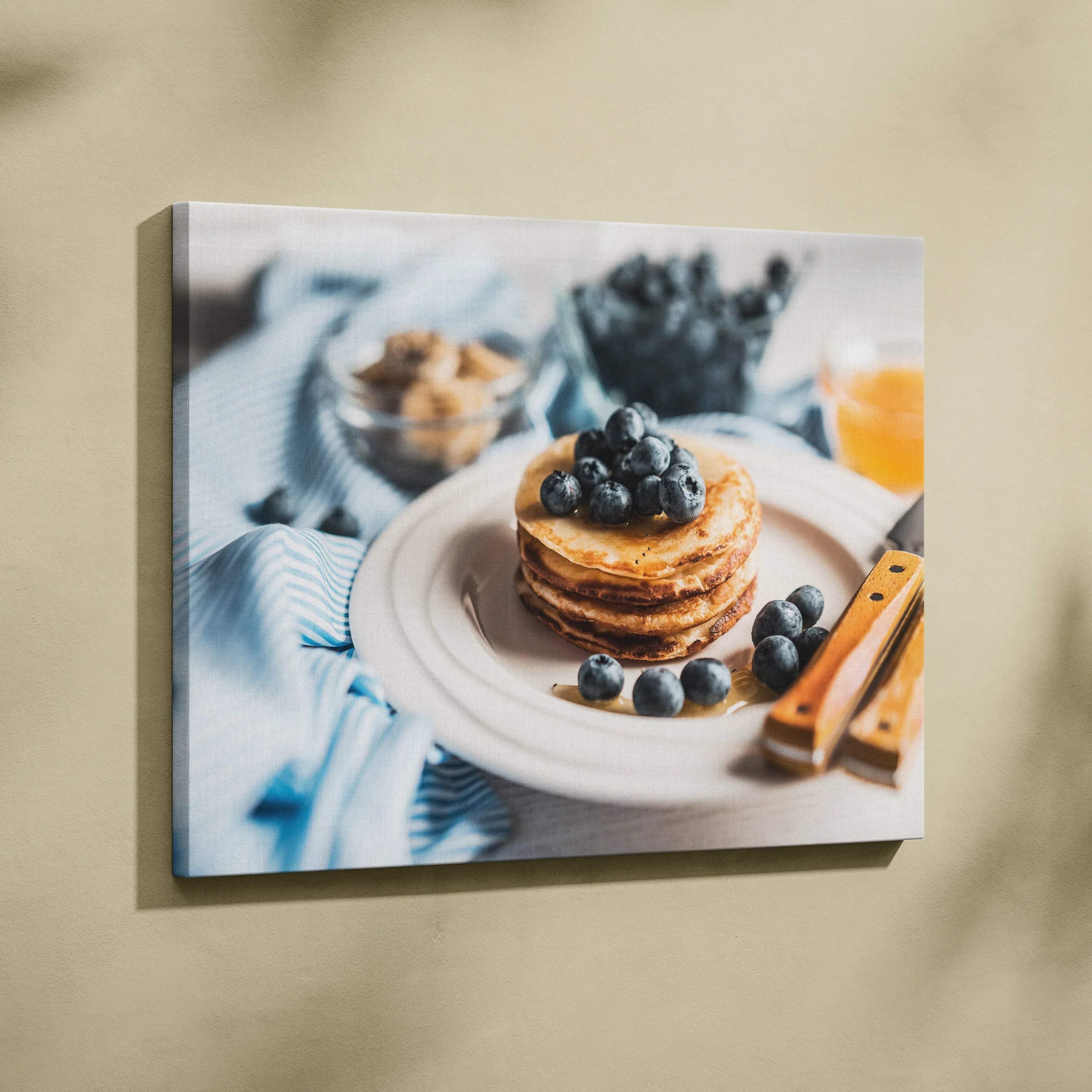 Canvas wall art featuring vibrant blueberry pancakes on a white plate with rustic decor background.