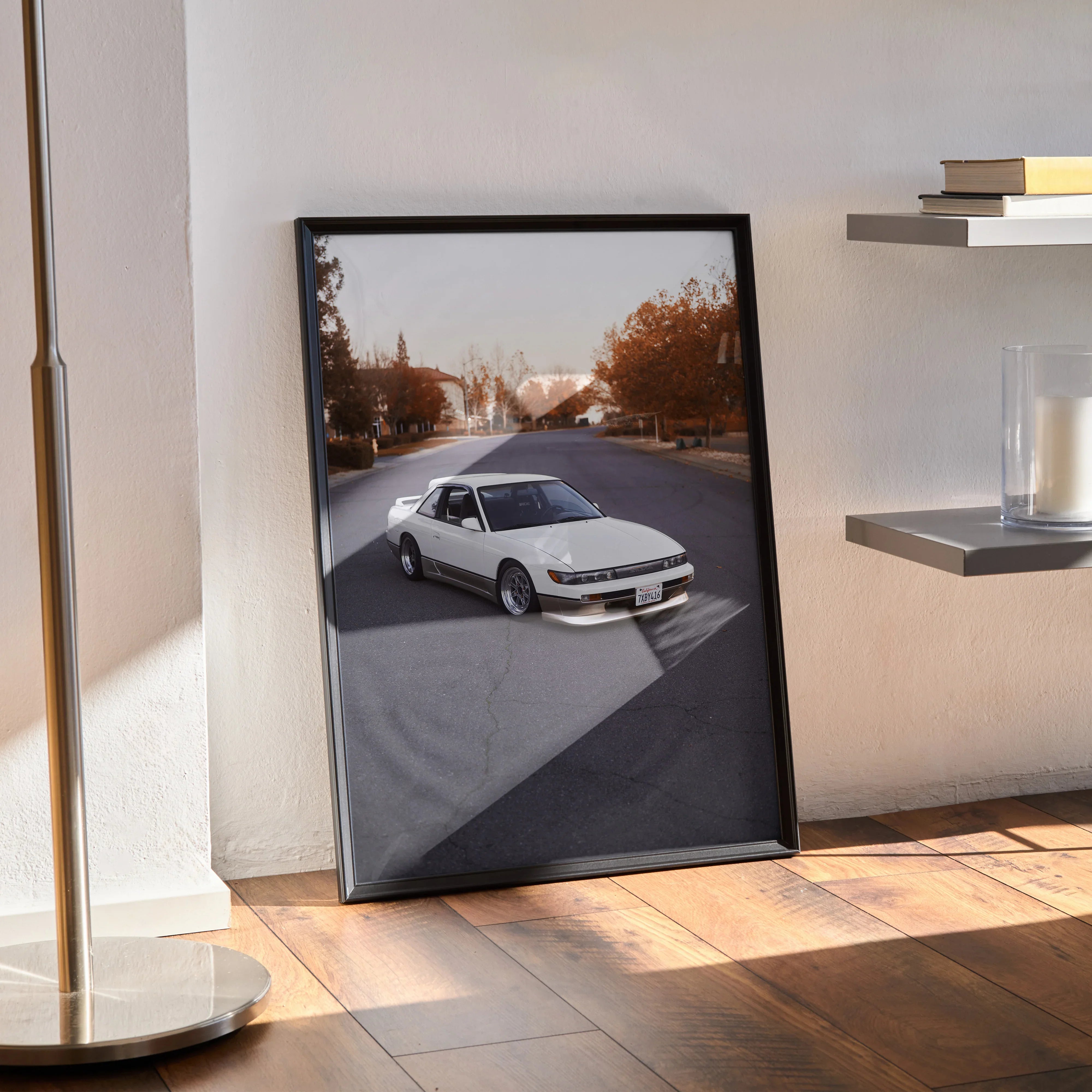 Nissan 240sx S13 Silvia poster featuring car on sunlit street, framed wall art with modern black frame.