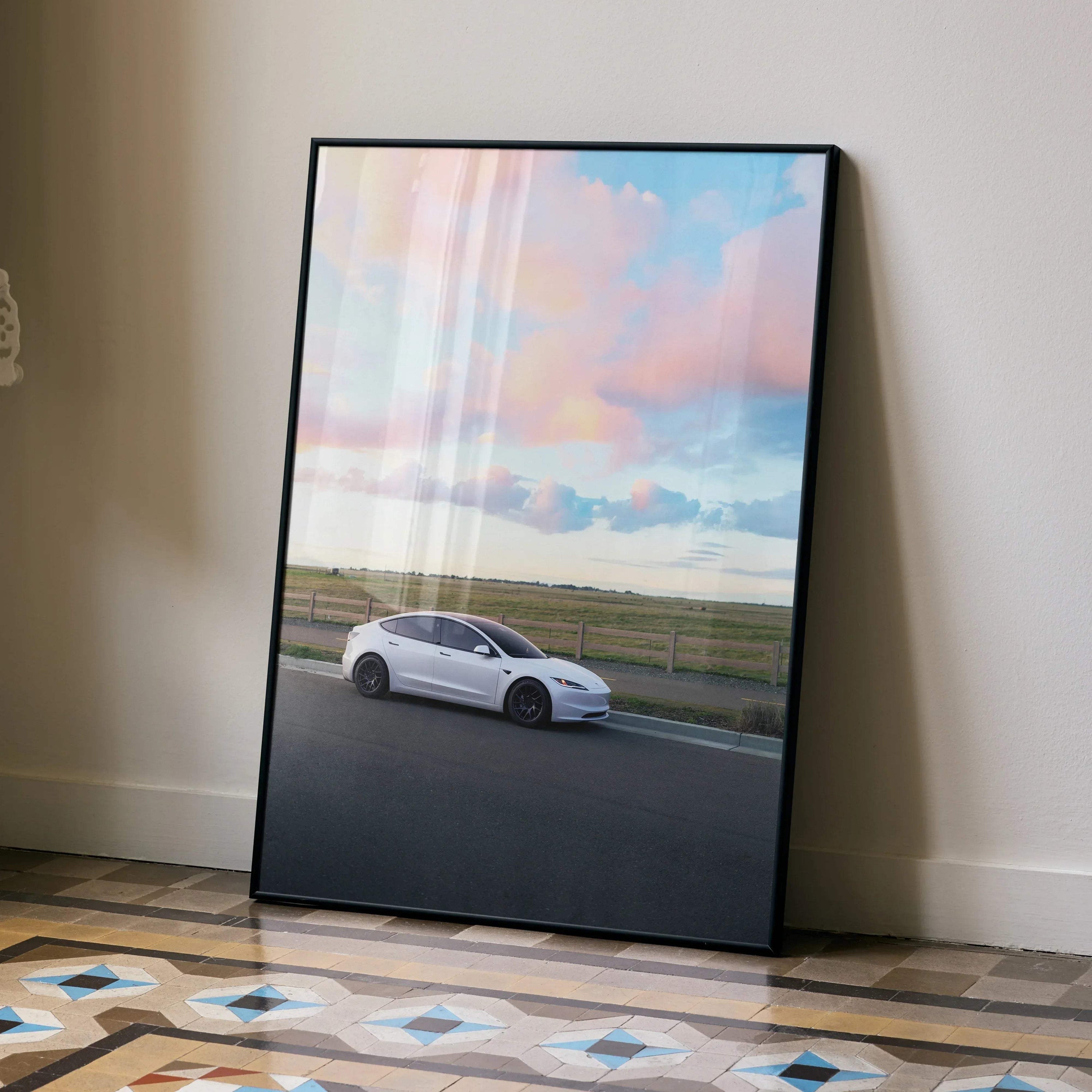 Tesla Model 3 Highland poster with white car and colorful sky wall art in black frame.