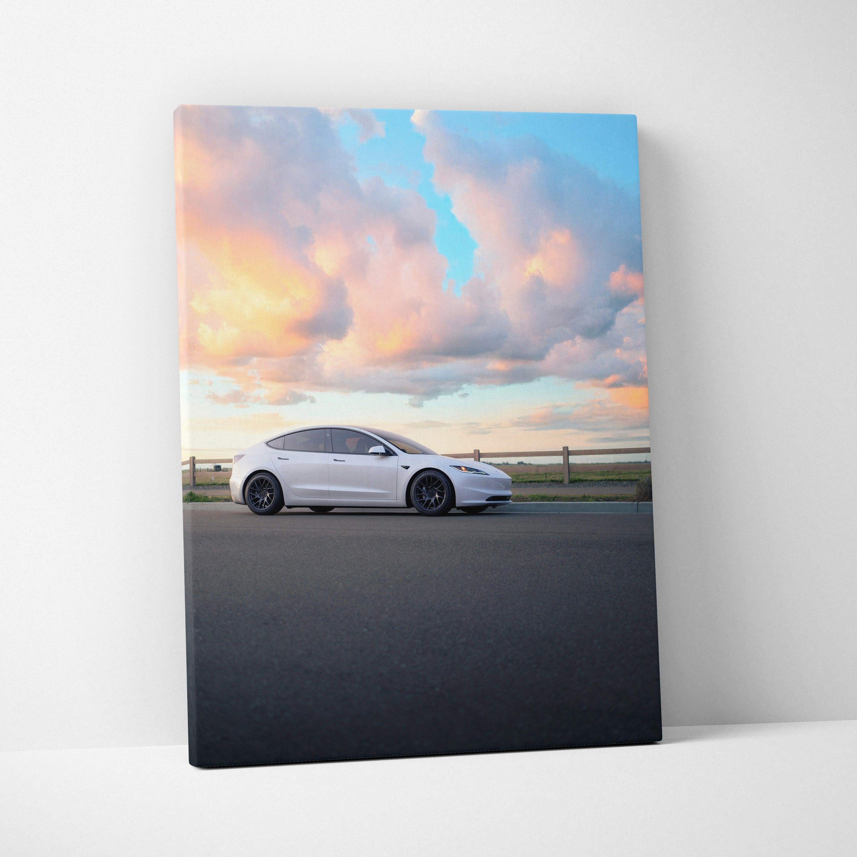 Vertical canvas wall art of white Tesla Model 3 Highland against colorful sunset sky.