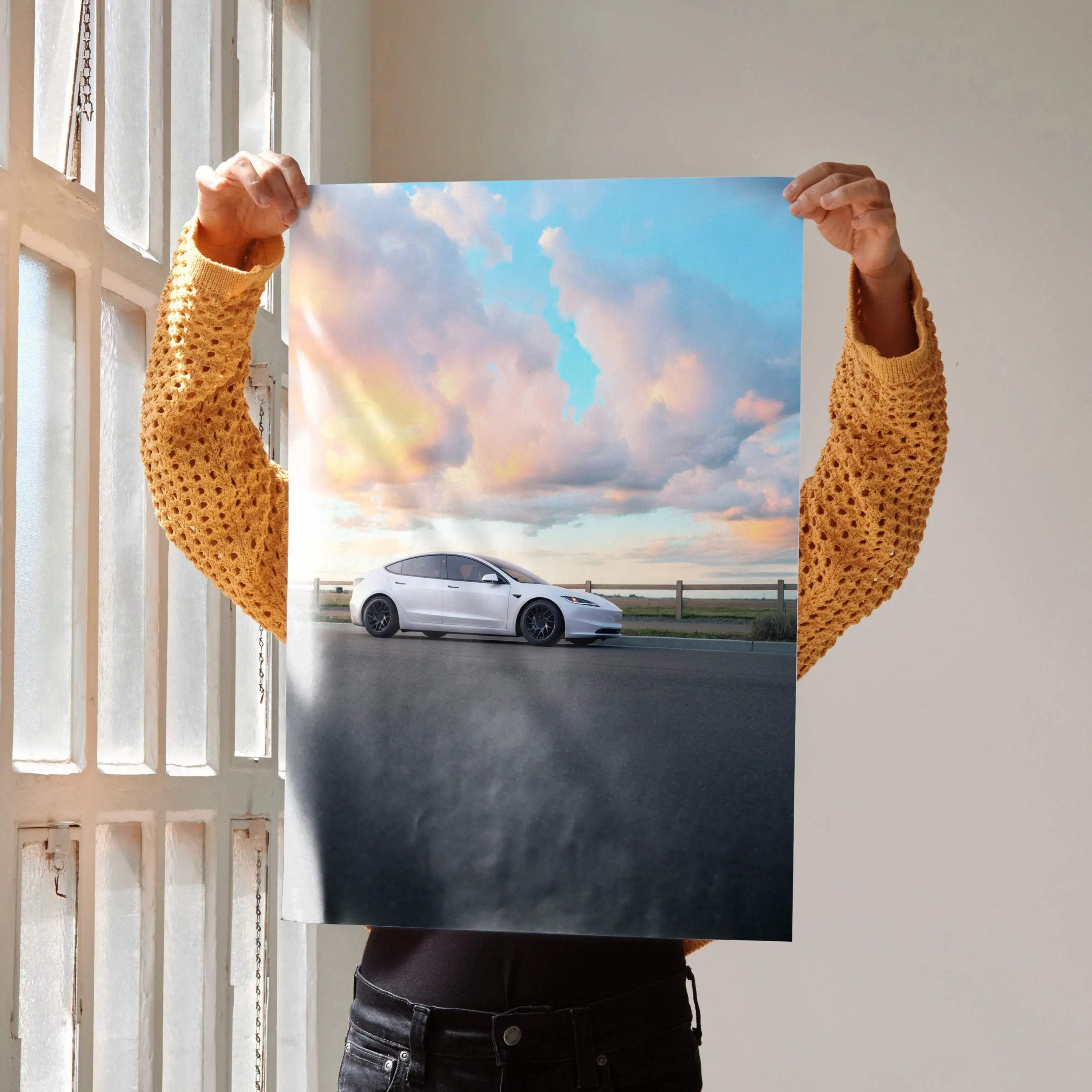 Tesla Model 3 Highland parked by a road under a colorful sunset sky poster wall art.
