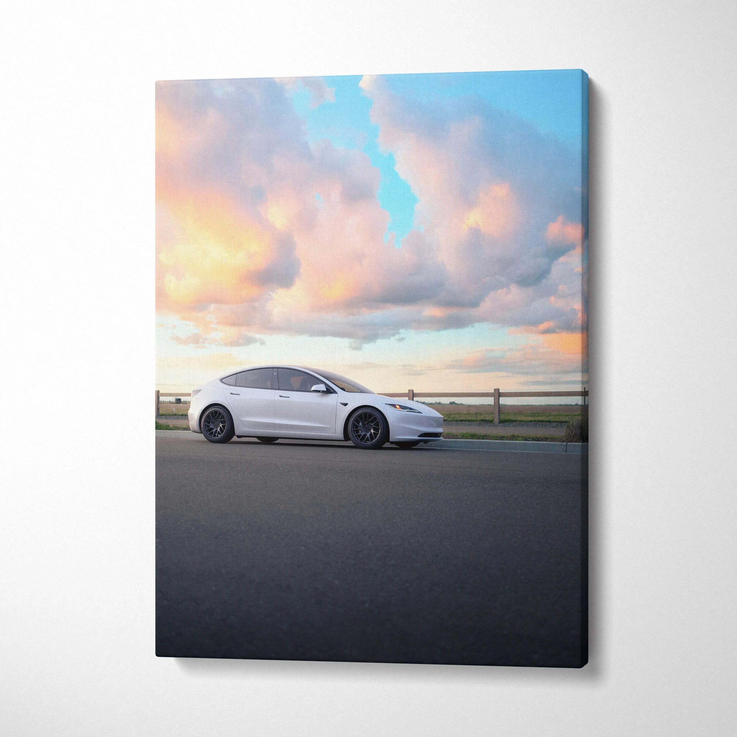 Vertical canvas wall art showing white Tesla Model 3 Highland under vibrant sunset sky.