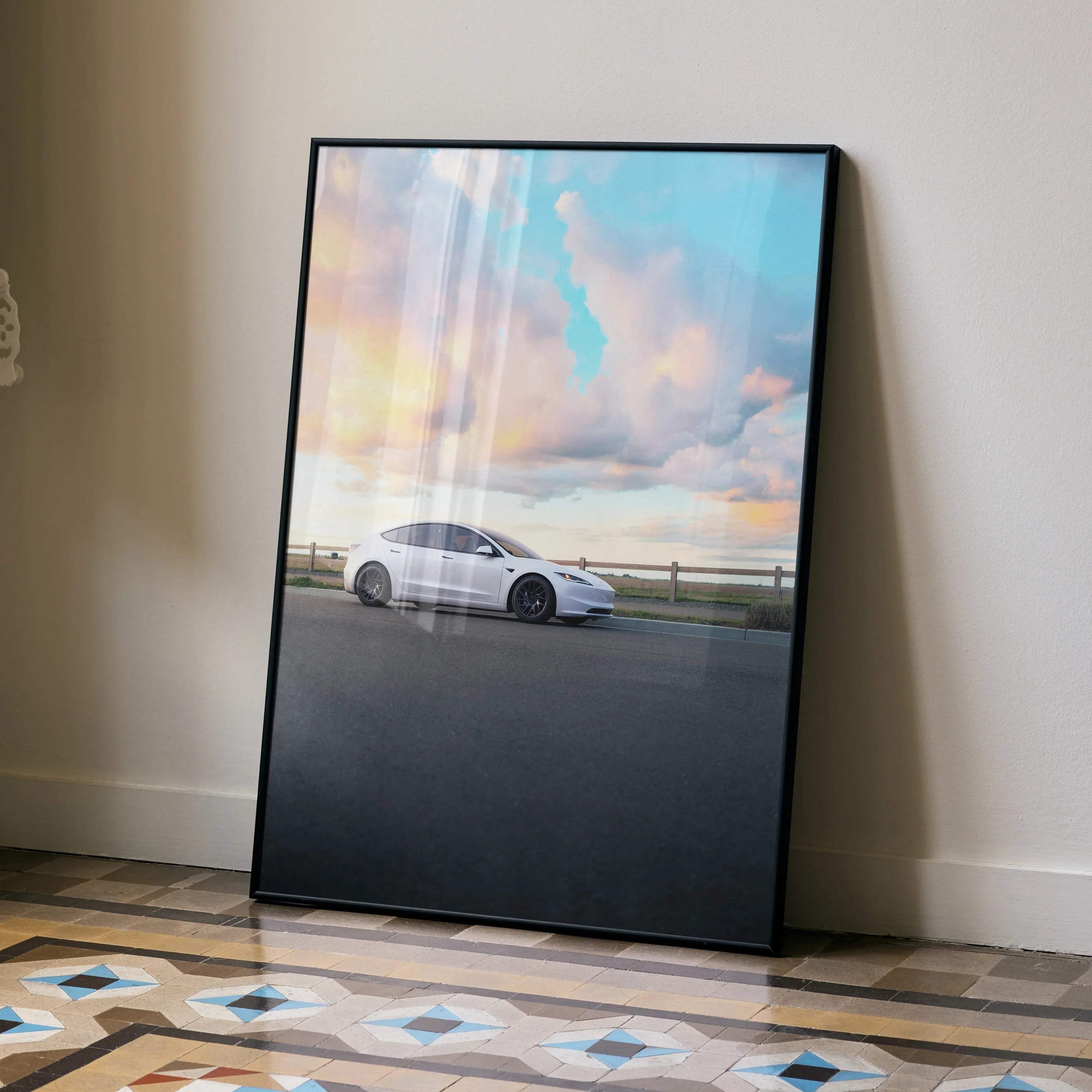 Tesla Model 3 Highland poster with white car against a colorful sunset sky, wall art in black frame.