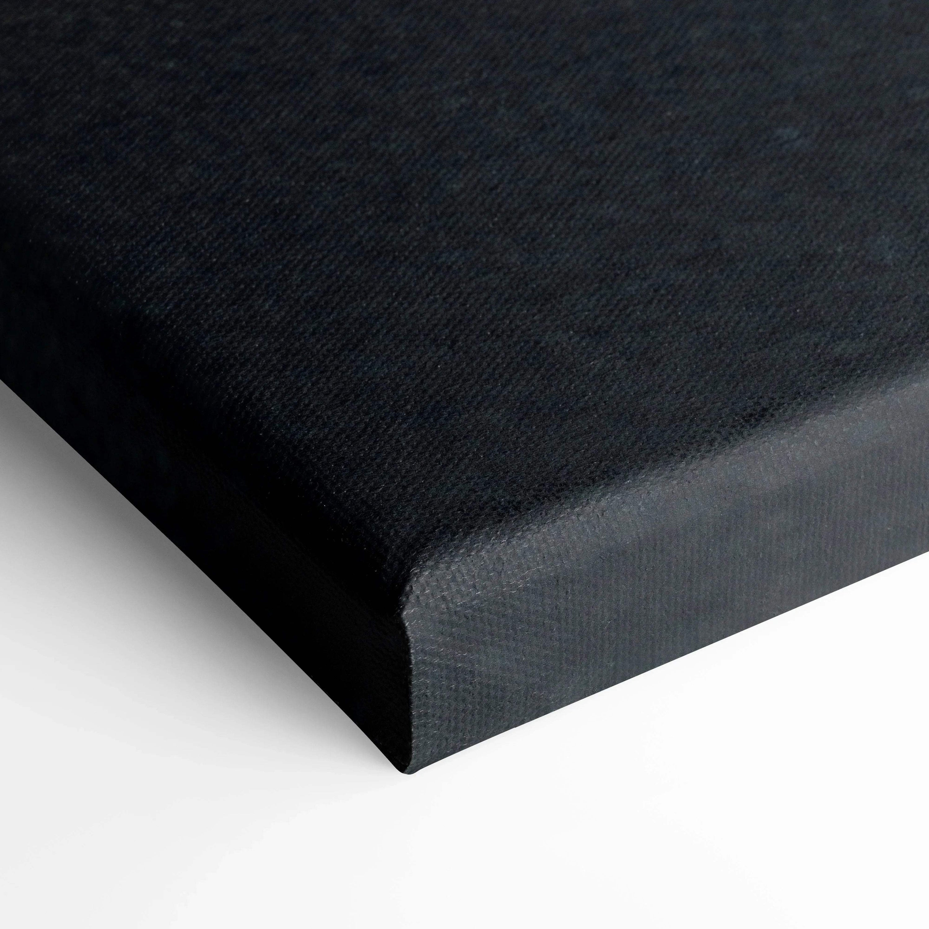 Close-up of black wrapped canvas wall art with textured fabric surface and clean edges.