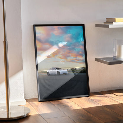 Tesla Model 3 Highland parked under colorful sunset sky, minimalist poster wall art in black frame.