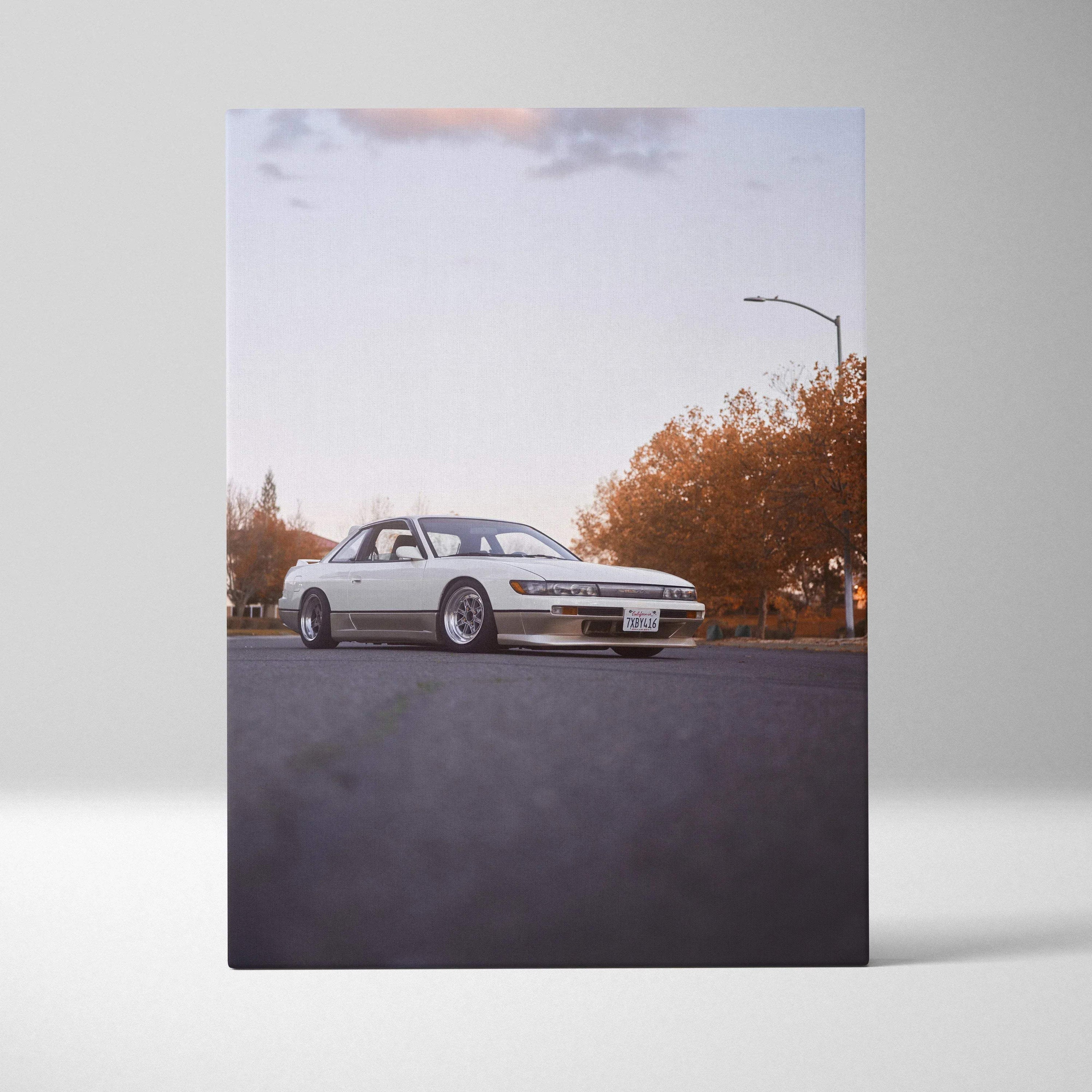 Vertical canvas art featuring a white Nissan 240sx S13 Silvia on an asphalt road with autumn trees in the background.