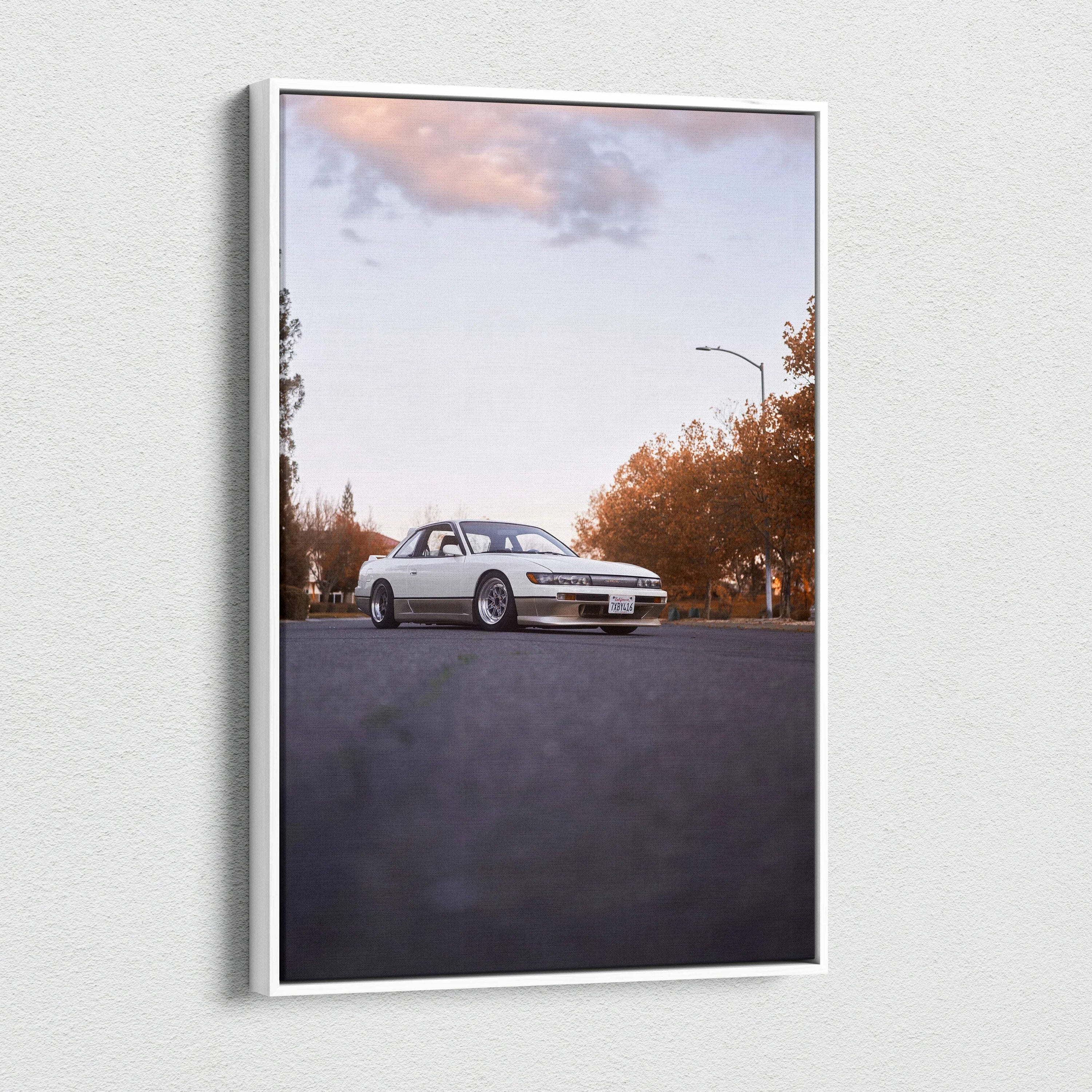 Vertical canvas wall art featuring a white Nissan 240sx S13 Silvia on an empty road under a cloudy sky.