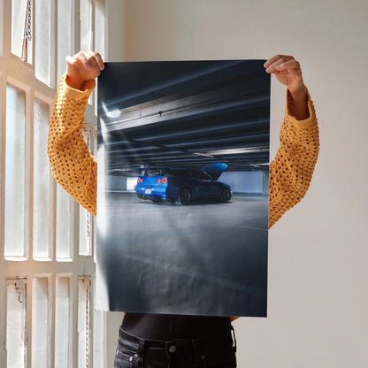 Nissan R34 GTR Skyline in blue parked in dark urban setting poster wall art.