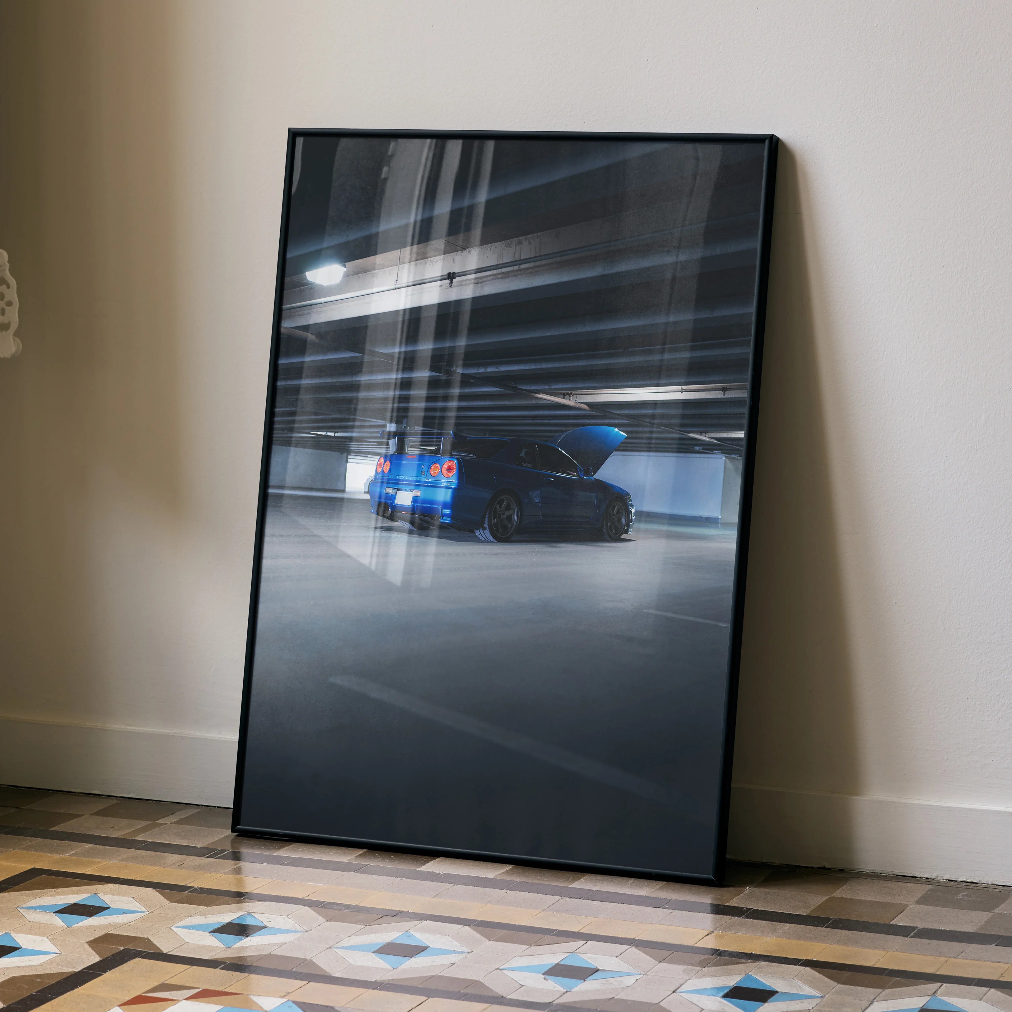 Nissan R34 GTR Skyline Poster with blue car in motion, sleek wall art in black frame.