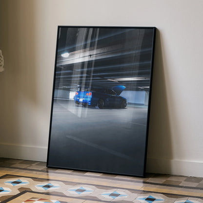 Nissan R34 GTR Skyline Poster with blue car in motion, sleek wall art in black frame.