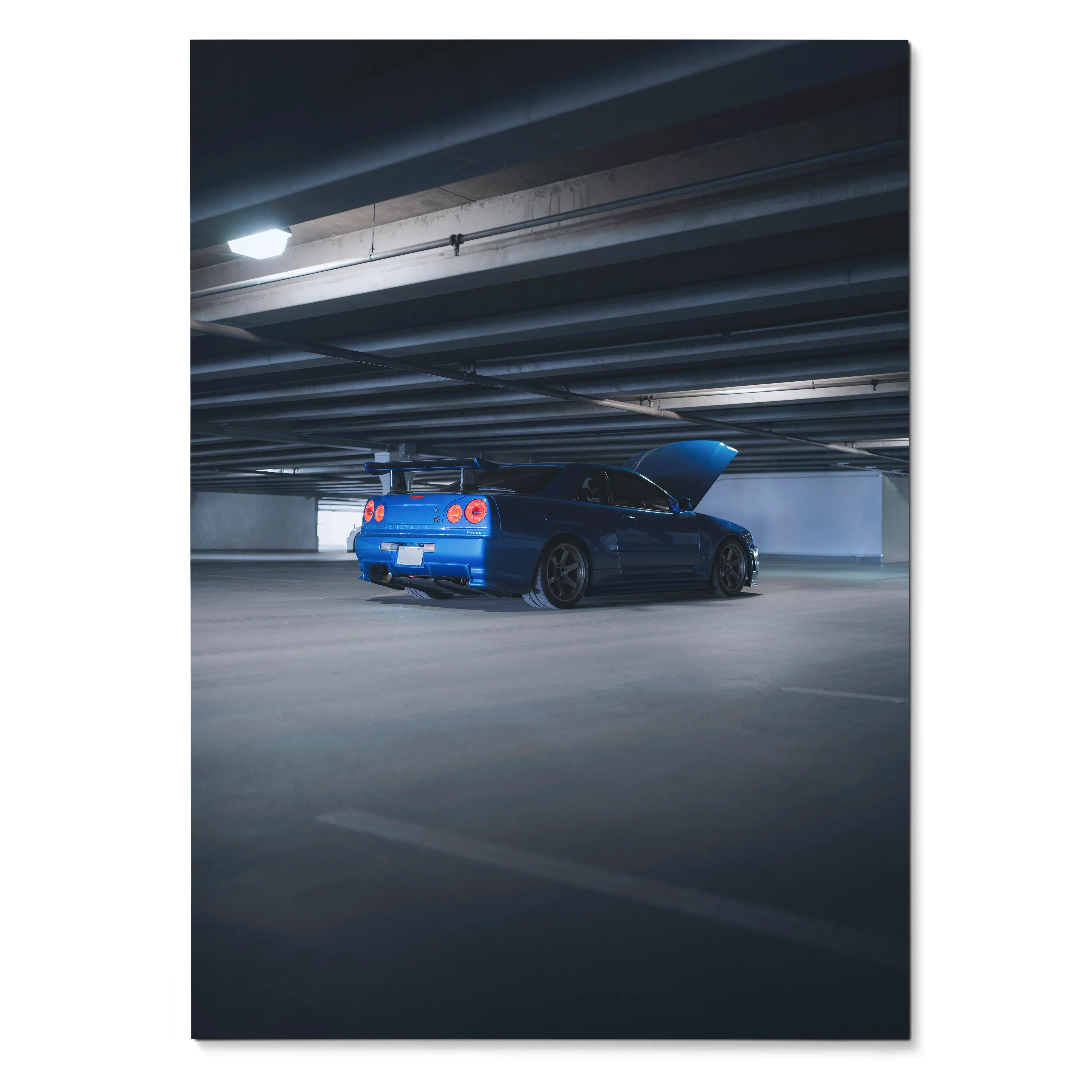 Nissan R34 GTR Skyline in blue parked under garage lighting poster wall art.