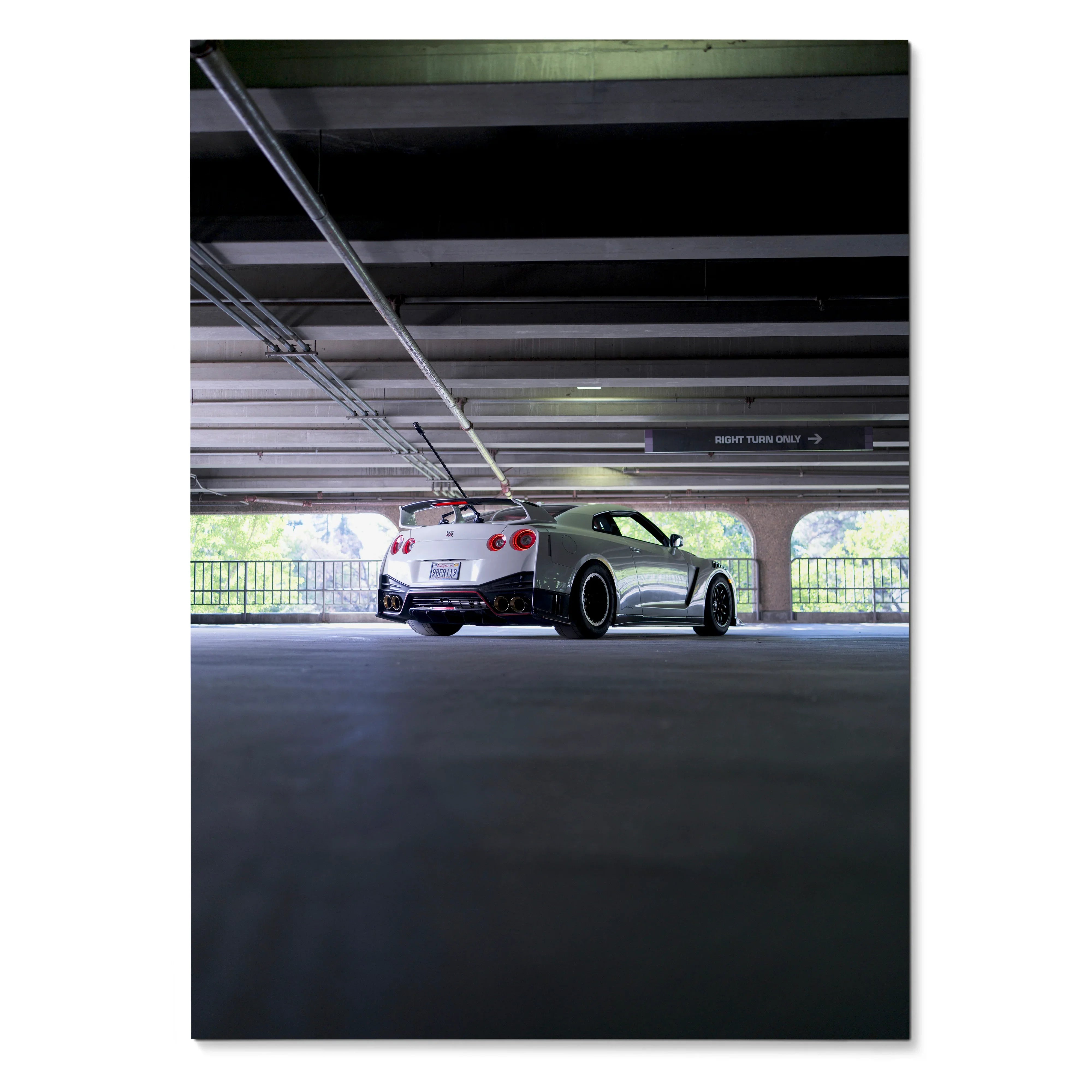 Nissan GTR R35 sports car parked in a dimly lit garage poster wall art.