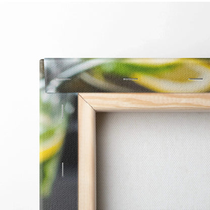 Close-up of natural wood-framed canvas print featuring vibrant lemon water in glasses with green background, wall art decor.