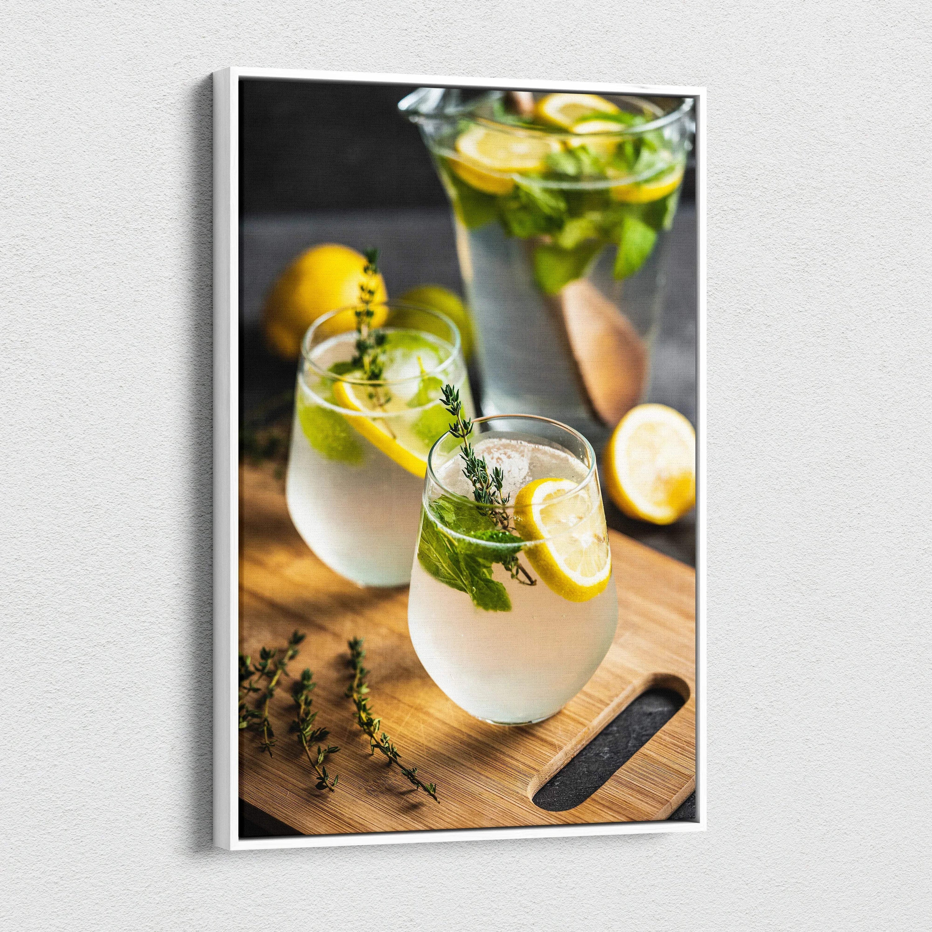 Canvas wall art featuring vibrant lemons and mint leaves in clear glasses of water on a wooden surface with a blurred dark.