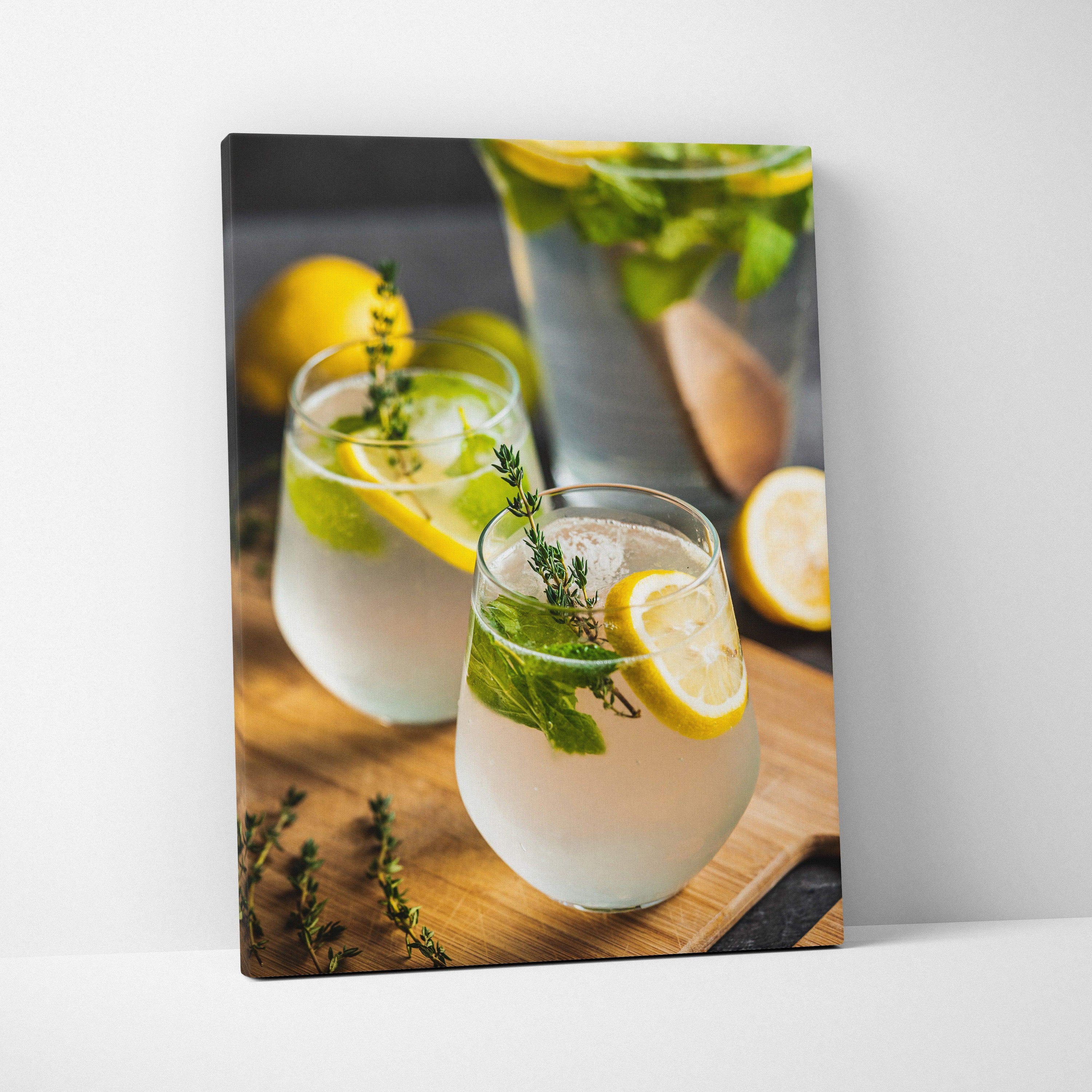 Vertical canvas wall art decor featuring vibrant lemon water glasses with fresh herbs on wooden surface.