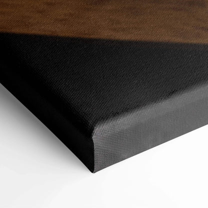 Close-up of black stretched canvas edge with smooth texture and tight corners.