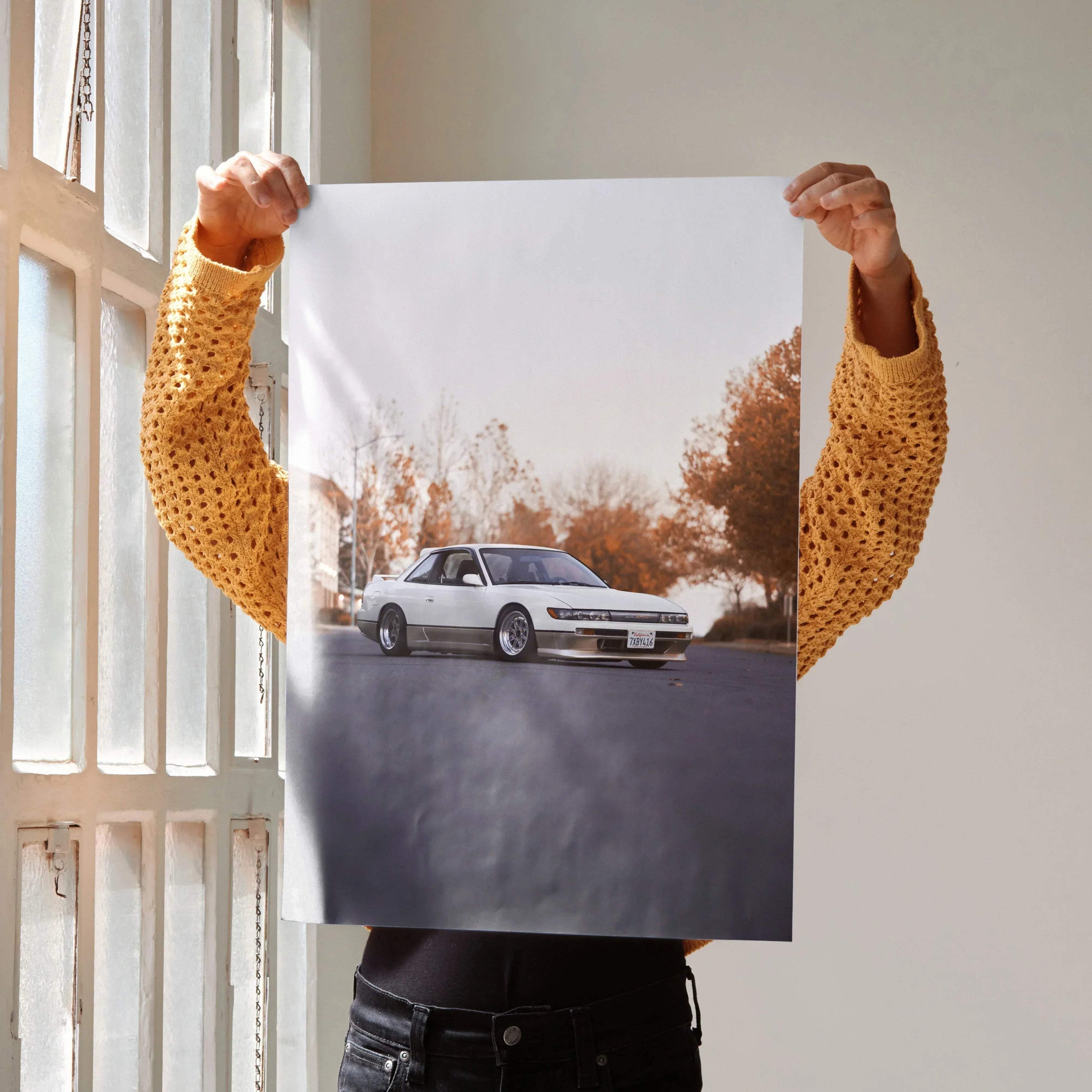 Poster wall art featuring a white Nissan 240sx S13 Silvia on a road with autumn trees in the background.
