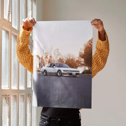 Poster wall art featuring a white Nissan 240sx S13 Silvia on a road with autumn trees in the background.