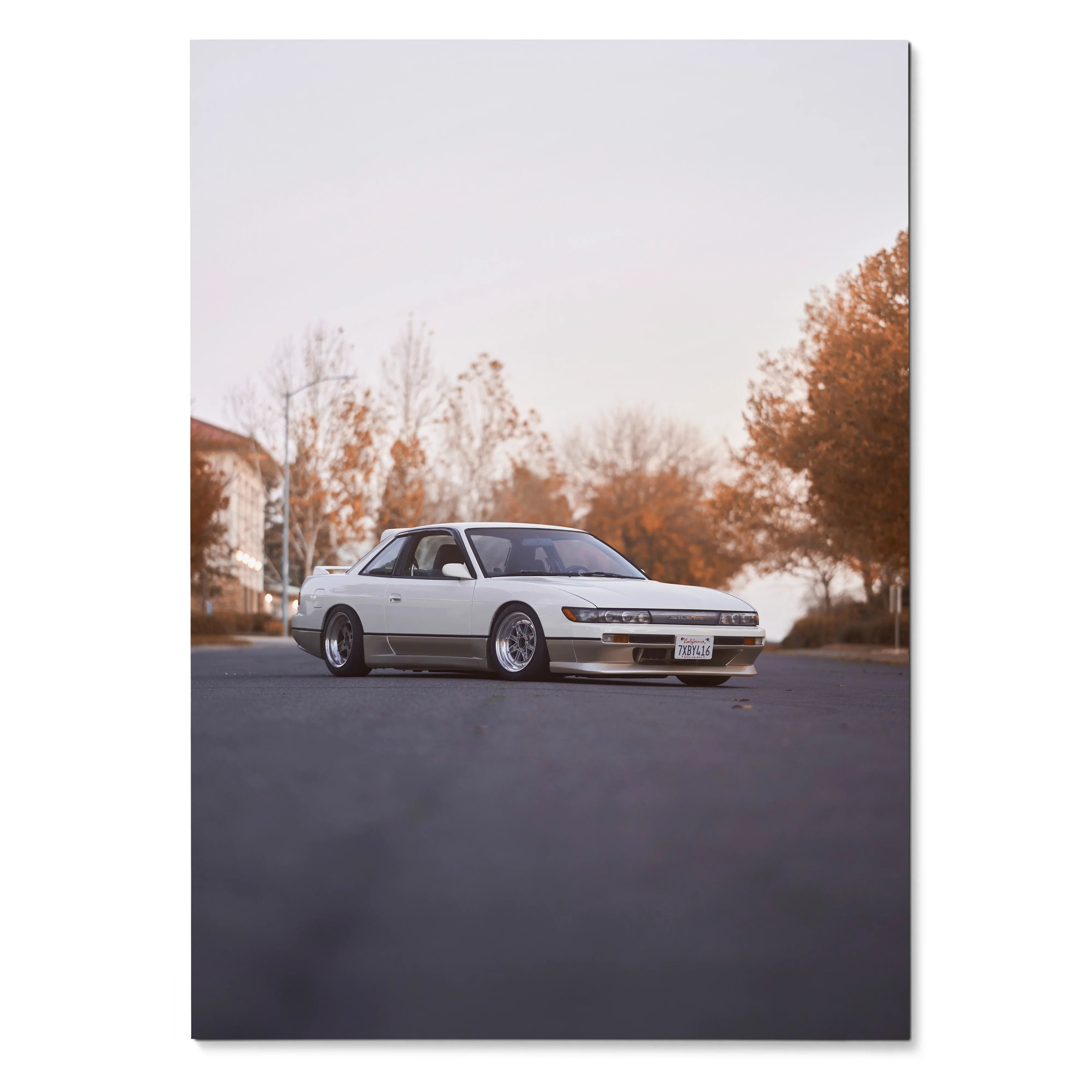 White Nissan 240sx S13 Silvia parked on street with autumn trees in background poster wall art.