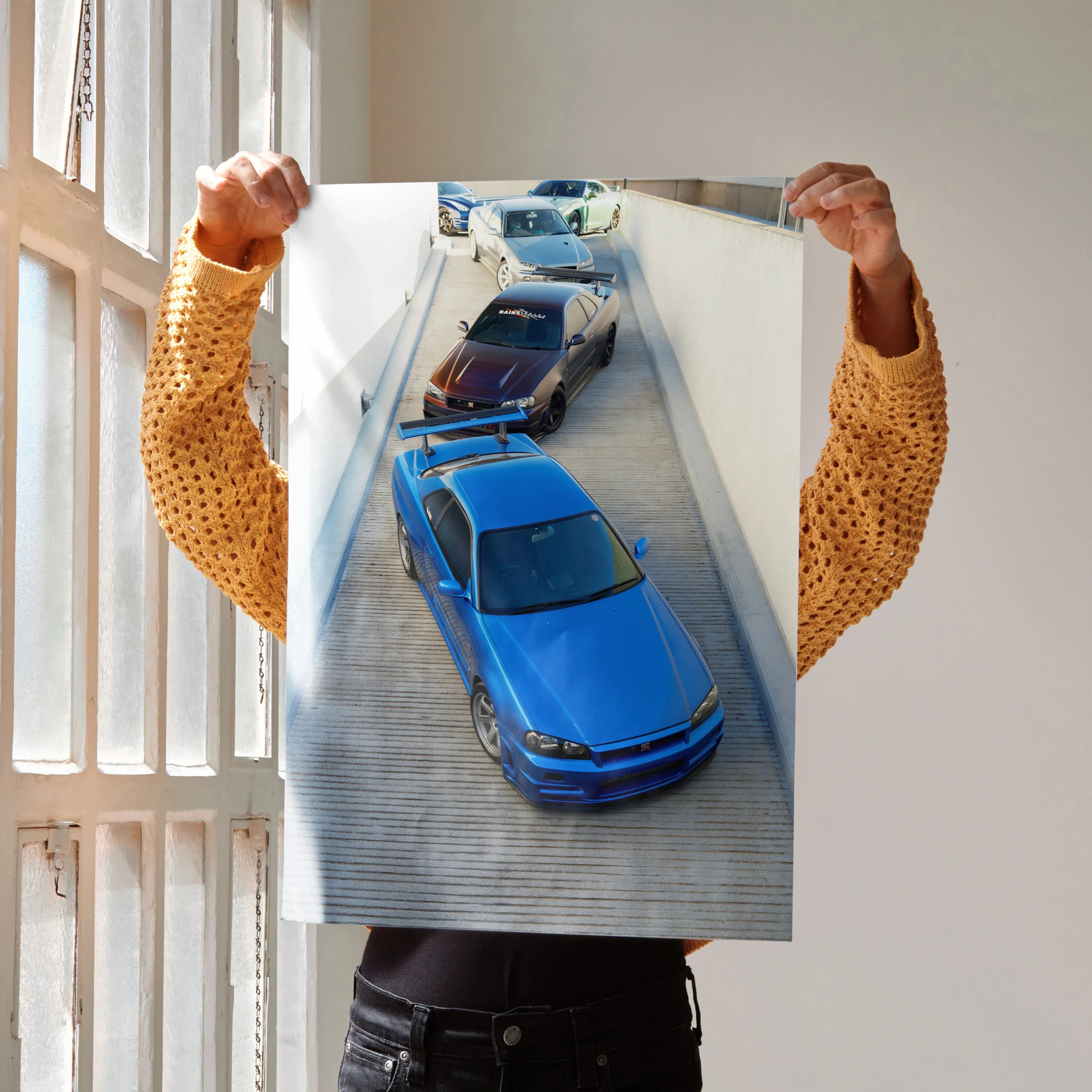 Nissan R34 GTR Skyline poster showing two blue sports cars on a modern concrete ramp wall art.