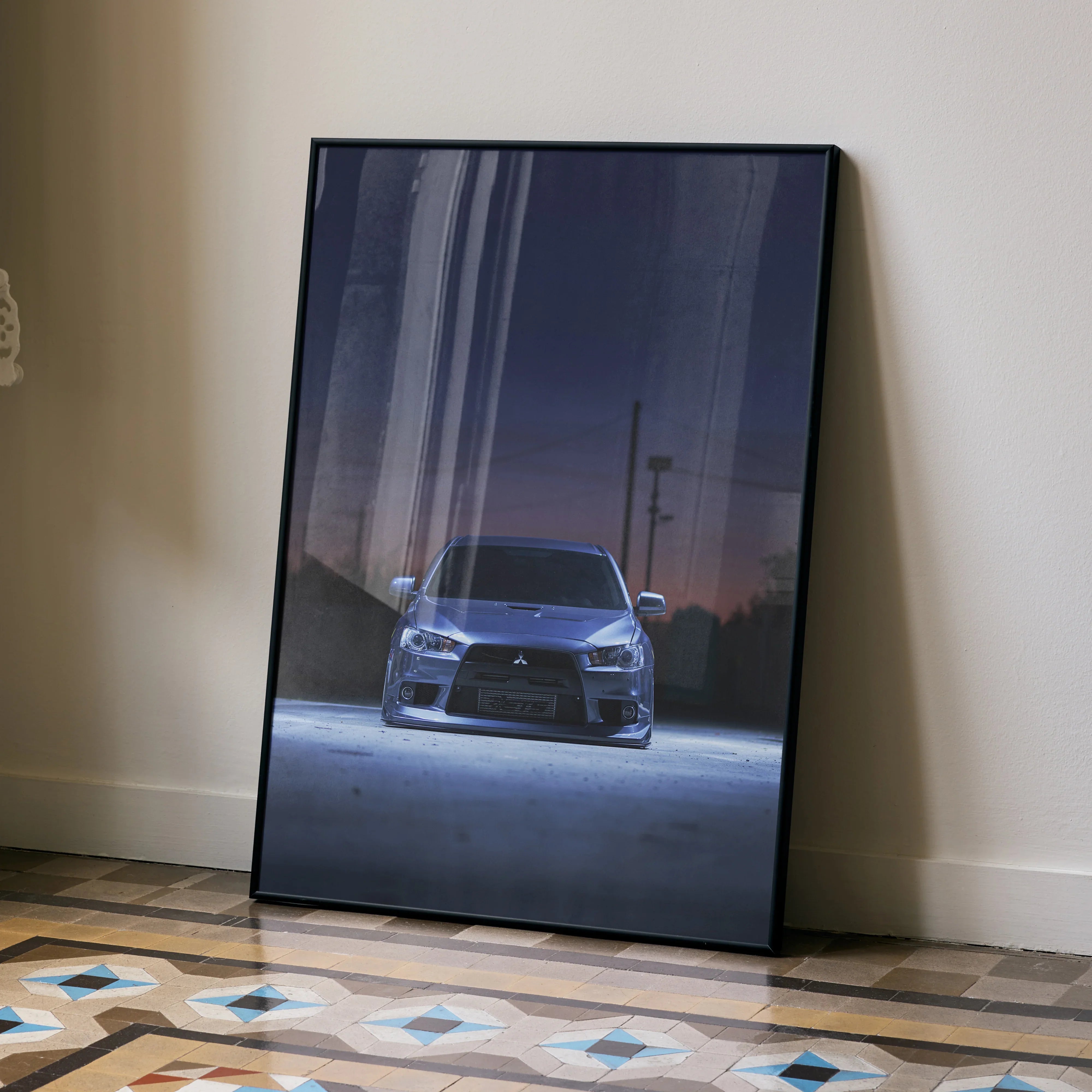 Mitsubishi Evo X poster wall art with front view of car at dusk in sleek black frame.