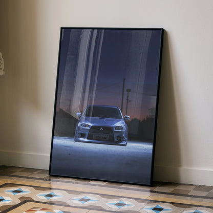 Mitsubishi Evo X poster wall art with front view of car at dusk in sleek black frame.