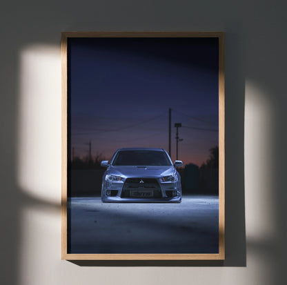 Mitsubishi Evo X in dark setting poster wall art with sleek car front view in wooden frame.