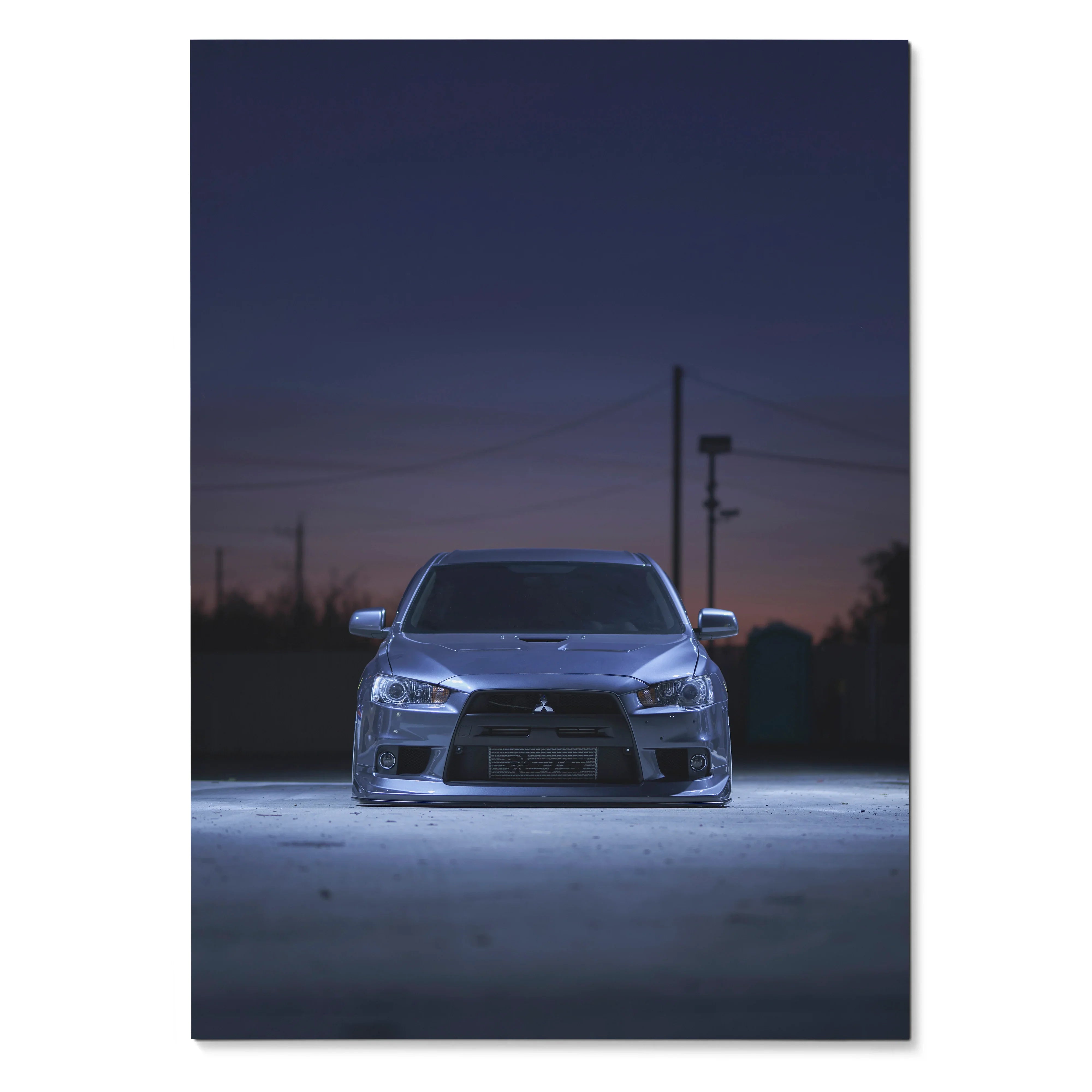 Mitsubishi Evo X front view poster with sleek headlights and dark evening sky wall art.