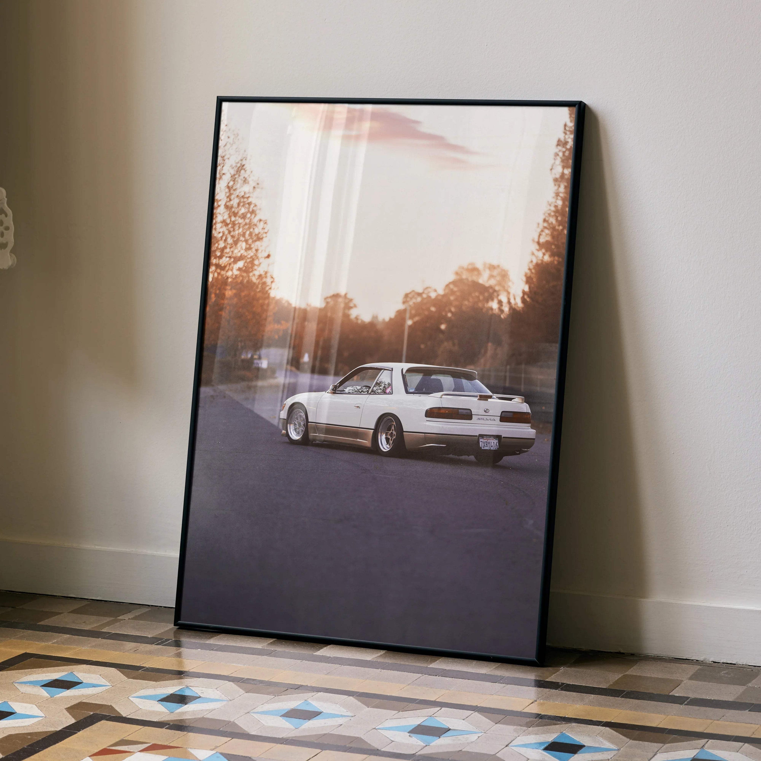Nissan 240sx S13 Silvia poster wall art featuring rear view of white car on road at sunset.