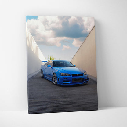 Vertical canvas wall art of blue Nissan R34 GTR under a cloudy sky in a minimalist outdoor setting.