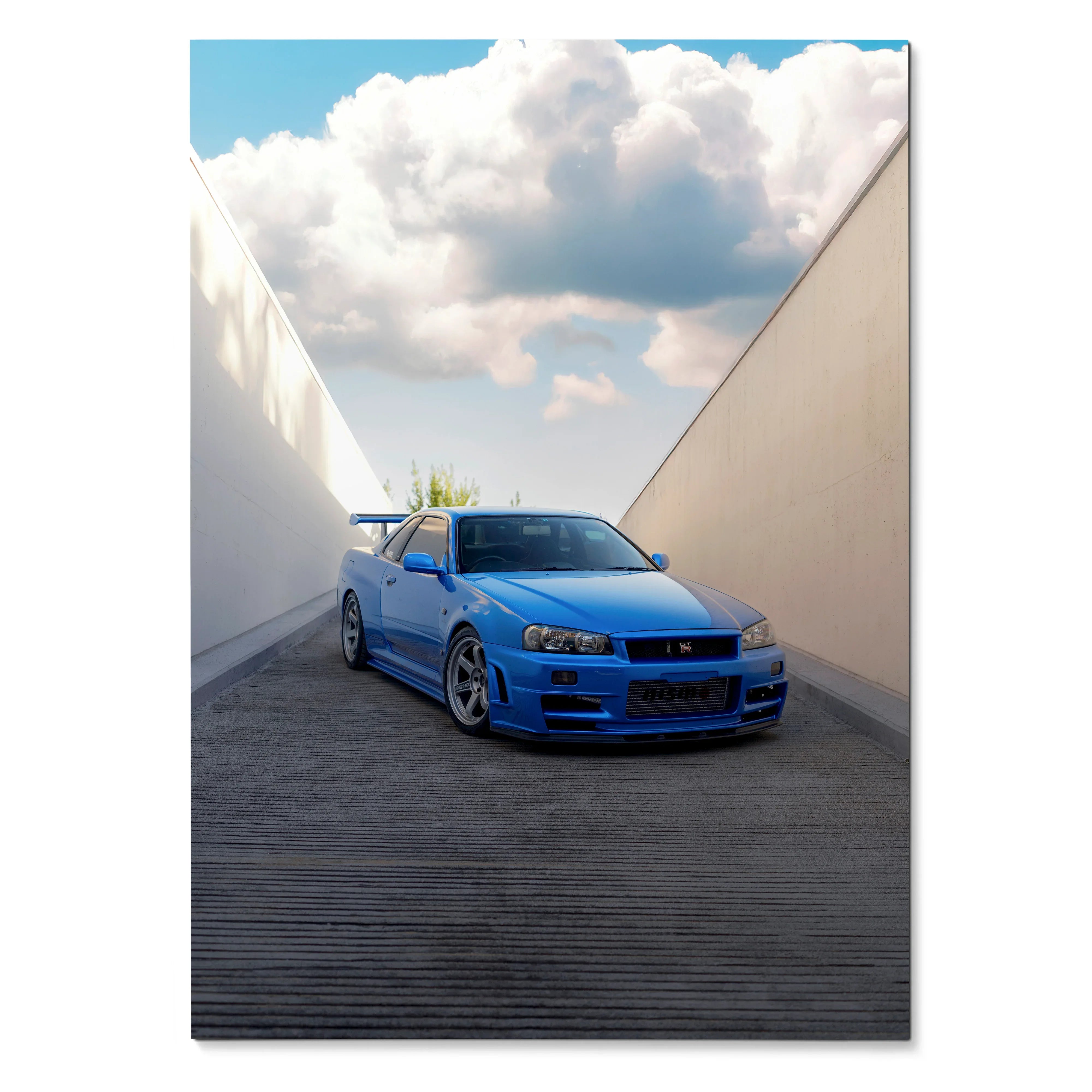 Blue Nissan R34 GTR Skyline parked in narrow alley poster wall art with cloudy sky background.