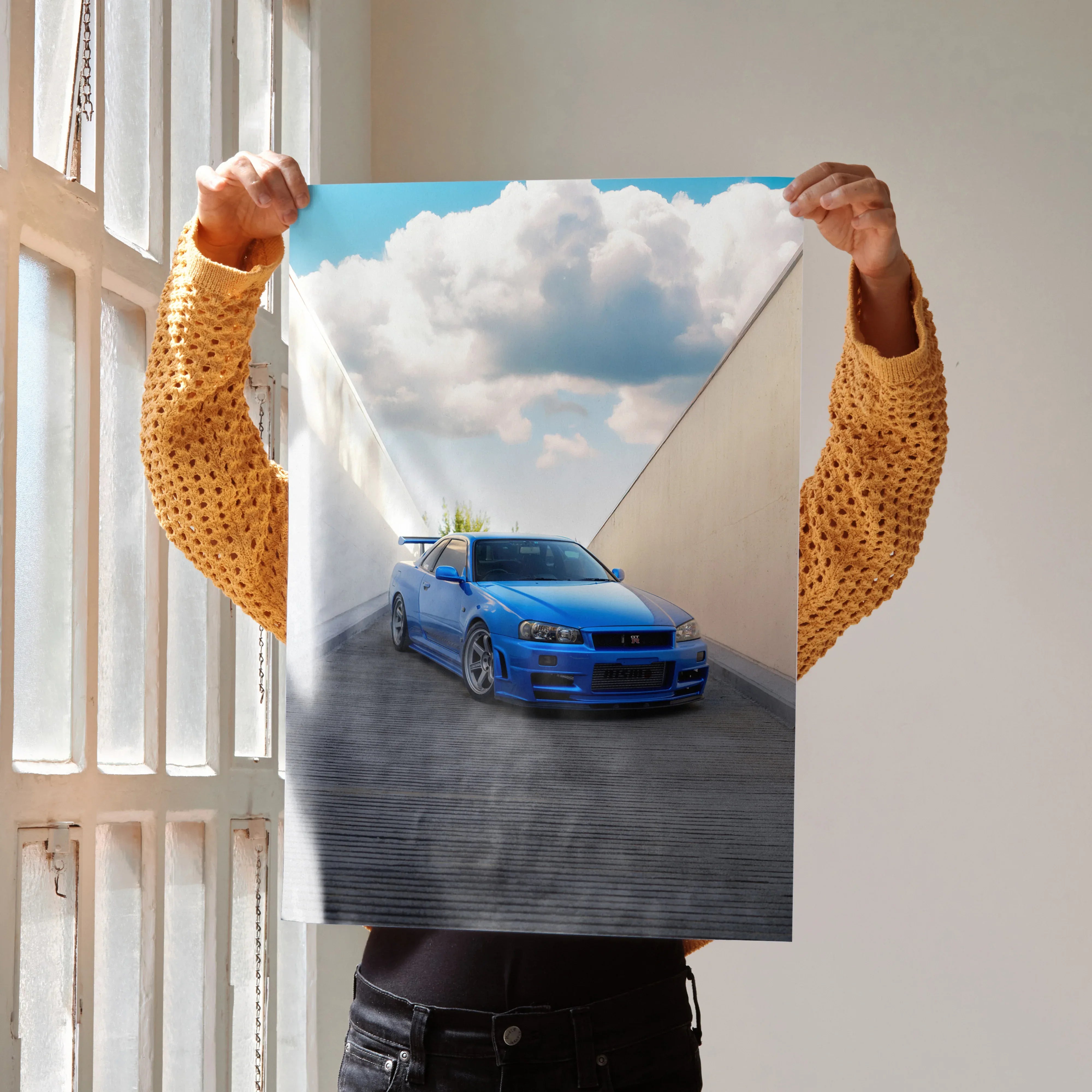 Nissan R34 GTR Skyline poster with vibrant blue car and dramatic sky, wall art for car enthusiasts.