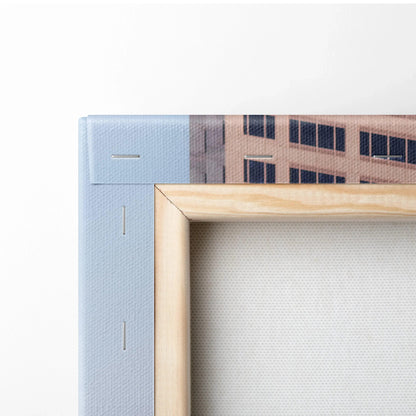 Close-up of wooden frame corner with blue and beige canvas art for wall decor.