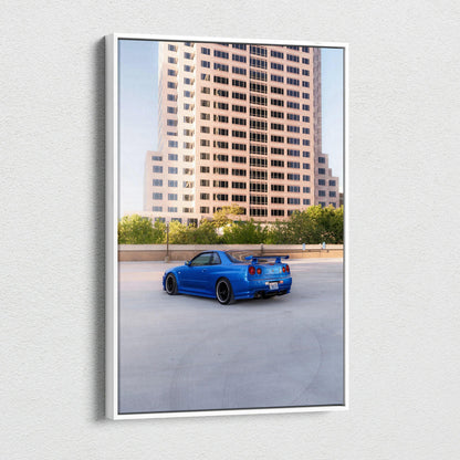 Vertical canvas art of blue Nissan R34 GTR parked near city building wall art print.