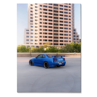Blue Nissan R34 GTR Skyline parked on rooftop with city building background poster wall art.