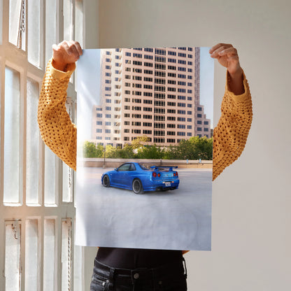 Nissan R34 GTR blue sports car poster with city skyline background wall art.