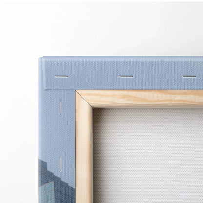 Close-up of light blue edge and light wood frame corner on vertical canvas art wall print.
