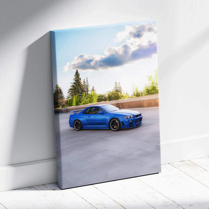 Blue Nissan R34 GTR parked under blue sky on vertical canvas wall art.