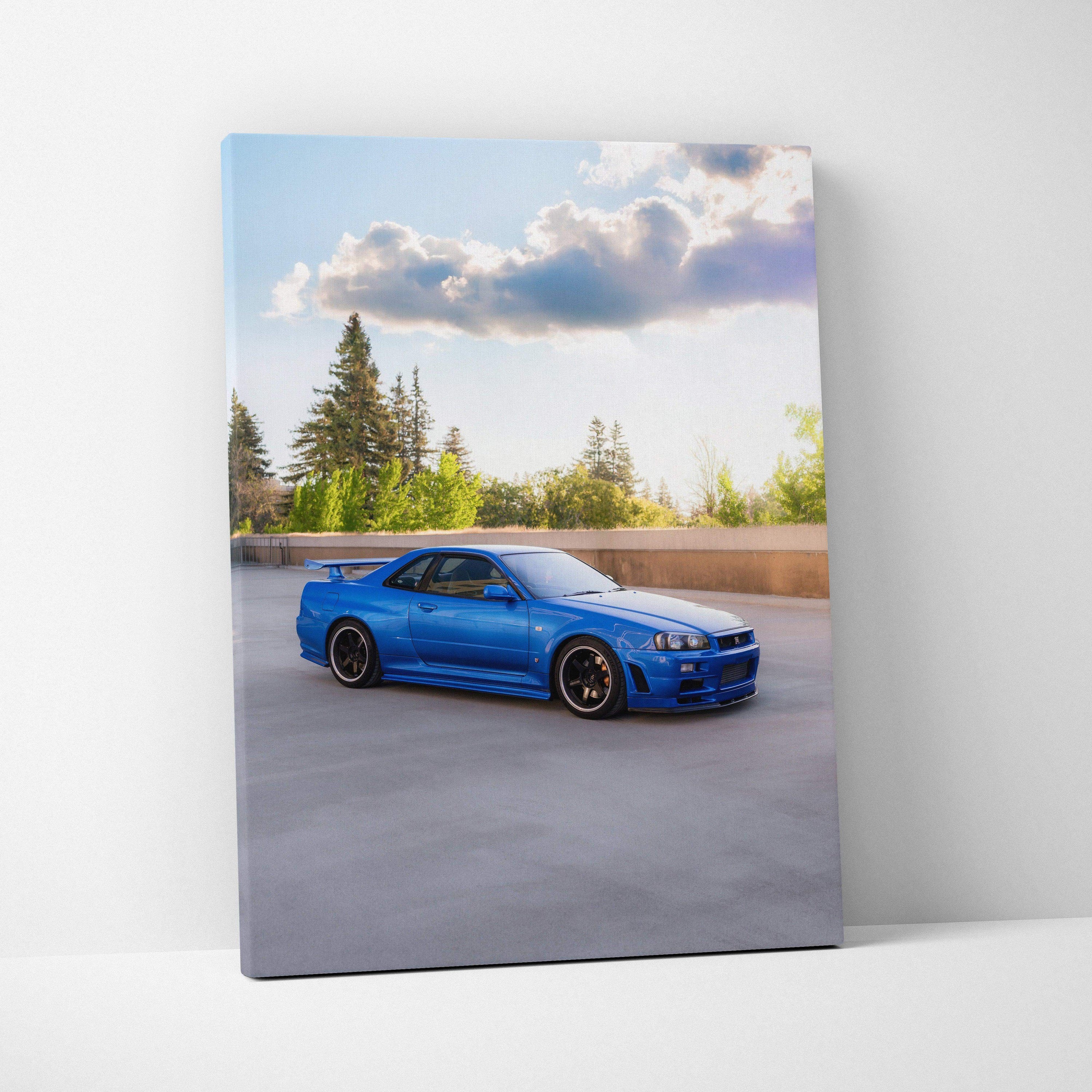Blue Nissan GTR R34 Skyline parked on rooftop, vertical canvas wall art with clear sky background.