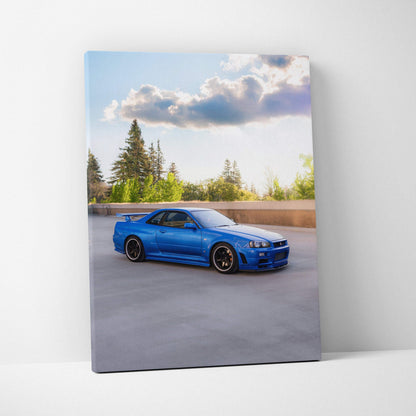 Blue Nissan GTR R34 Skyline parked on rooftop, vertical canvas wall art with clear sky background.